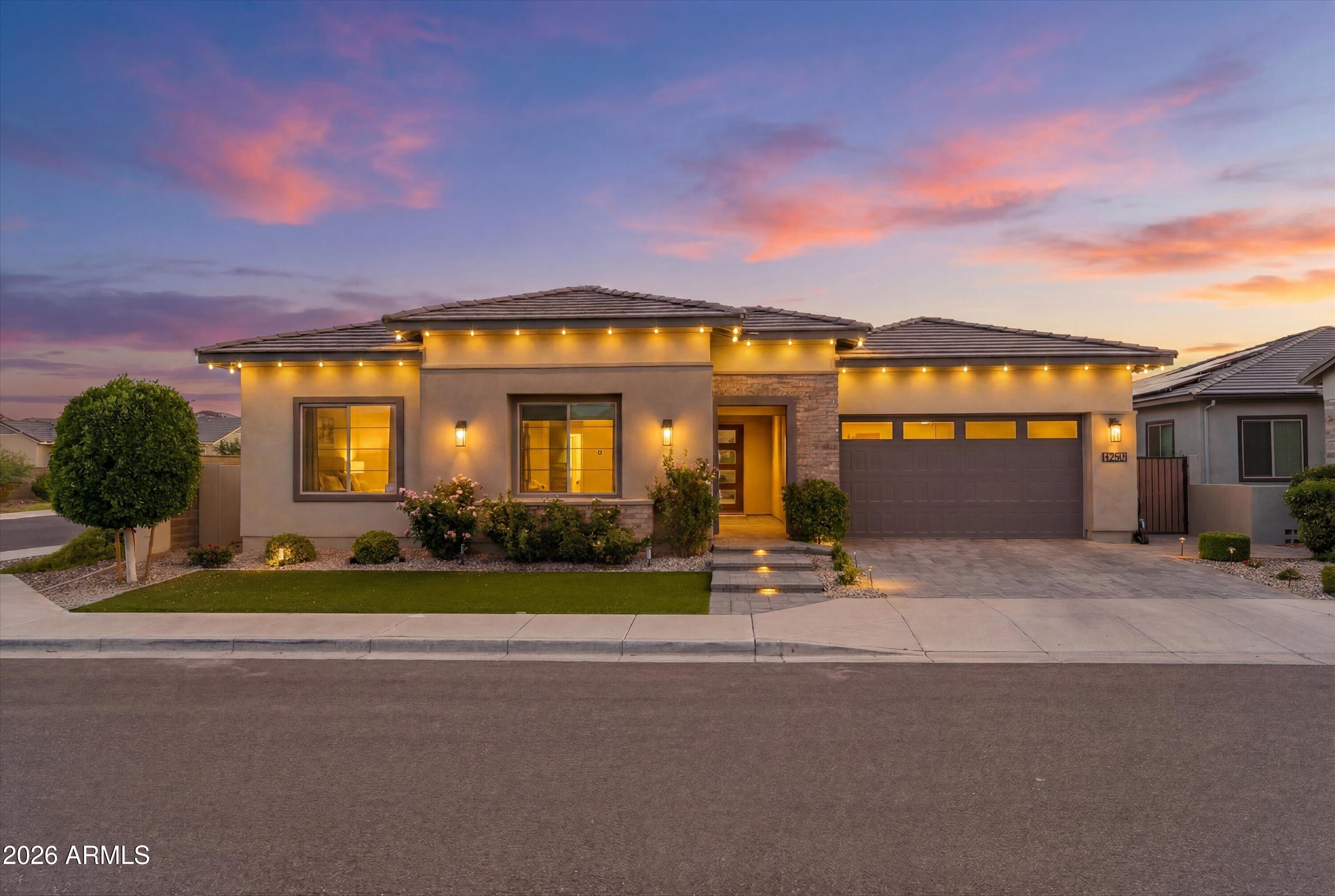Waterston is a desirable new community in South Gilbert.  Situated on Waterston North, a gated community with tons of greenspace, walking trails, lakes, and gathering areas.  Perfect for those who are seeking a great location & engaging community.
You'll fall in love with this spacious 4 bed, 3.5 bath home with tasteful upgrades throughout. Features tile plank flooring & carpeted bedrooms, two large sliders, and dual courtyards. There is also a bedroom  that includes an en-suite full bathroom.
The open floor plan provides space for entertaining while the Chef's kitchen is the focal point of the property.  The oversized island, quartz counters, backsplash, gas range, double oven, and GE Profile appliances all add to the luxury and functionality of this amazing kitchen! Across from your side courtyard you'll find a private office with glass doors and custom cabinetry, freshly painted. 
The oversized primary suite offers tons of natural light and a stunning custom-designed closet.  The custom barn door, separates the luxurious primary bath featuring a sauna shower with rain head, soaking tub, dual vanities, bidet, and custom closet. 

Outside you can enjoy your very own private retreat!  The beautifully landscaped backyard features turf, porcelain pavers, a high-end Heston outdoor kitchen, gas fireplace and irrigated garden beds.