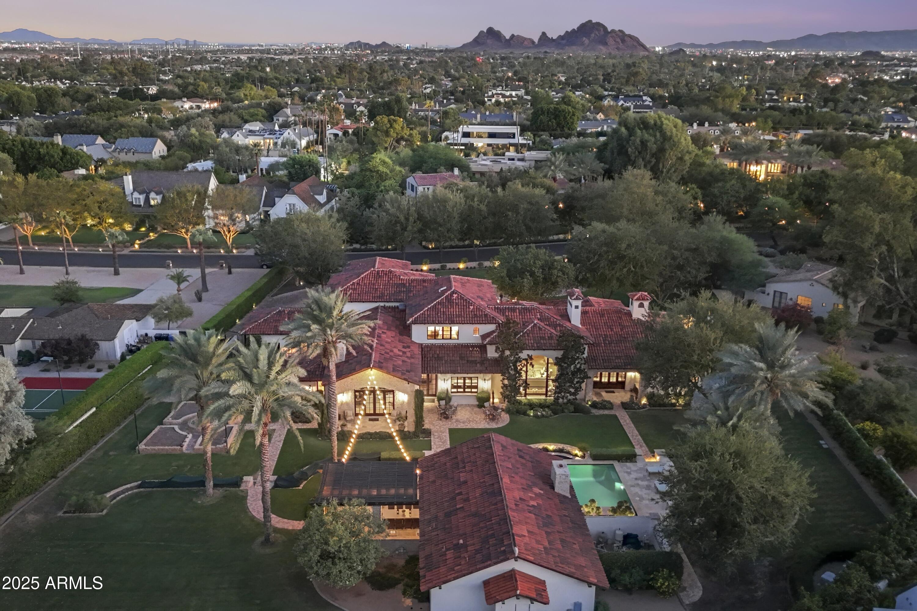 Positioned on one of Arcadia's most coveted and prestigious streets, this French-inspired Mediterranean estate stands as a true ''one-of-one'' residence of global caliber. Encompassing over 9,900 sqft and just under 1.5 acres; built by Stellar Development with uncompromising attention to detail, the home is a showcase of Old World artistry fused with modern refinement. Every element reflects bespoke craftsmanship: reclaimed antique hickory floors from Pennsylvania, Venetian plaster walls, a soaring double barrel-vaulted dining room, hand-scraped cabinetry, and a patio of French barrel-vaulted brick, custom cut on-site. Subtle touches—such as an antique horse trough garden sink—infuse timeless charm. The estate features... 5 bedrooms and 7 bathrooms, including dual His and Her primary baths, a sophisticated office overlooking, and access to its own serene courtyard. The state-of-the-art theater offers an automated retractable wall; when OPEN, the theater room extends into your everyday living space in addition to an upstairs game room with three private ensuite suites.

The grounds are as meticulously curated as the interiors, with mature trees, manicured lawns, and raised gardens surrounding a shimmering 745 sq ft glass-tiled pool. An 864 sq ft guest house extends the hospitality, while iconic Camelback Mountain creates an unrivaled backdrop, evoking the romance of Tuscany.

An estate of this pedigree is exceedingly rareand an irreplaceable expression of elegance, craftsmanship, and exclusivity in the heart of Arcadia.