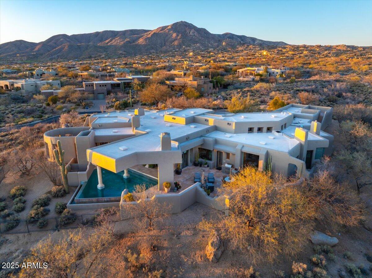Desert Mountain Golf Membership available, TURNKEY, and Home sits on combined lots 4 & 5 & PRICE now INCLUDES Lot #3 for ''forever views''. Centrally located within the community for easy access to all Golf Courses & amenities. This architectural gem seamlessly blends Old-World grandeur with Southwest flare as you enter into grand Living room with views to the Pool and multiple sitting areas with a strategically placed Wet Bar to service both Living & Family Rooms. Home boasts a very generous Primary Suite with dual Baths and Closets joined by shower, Office with built-in Bookcases, & expansive Guest Casita with Fireplace make for a perfect get-away for your Guest.  Entertaining at its best with water feature, multiple fireplaces, spa, and graciously covered pool to create shade.