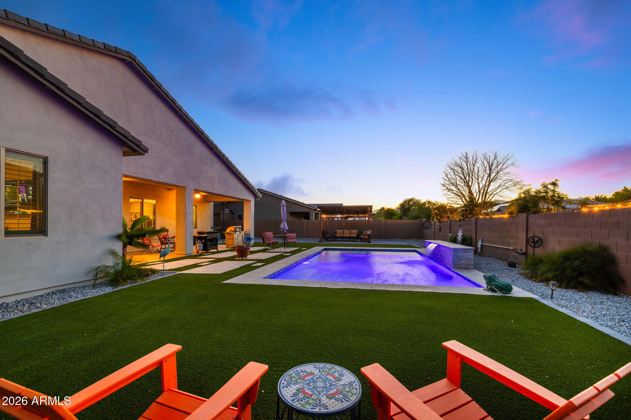 Designed for today's luxury lifestyle, this exceptional home offers 4 ensuite bedrooms, providing privacy and comfort for family and guests. The attached, insulated, climate-controlled Luxury Flex Garage includes A/C, a kitchenette, full bath, and space for vehicles, making it ideal for multigenerational living, guests, a home business, hobbies, or collector cars. An additional two-car garage and extended driveway provide ample parking and storage for multiple vehicles. The gourmet kitchen features an oversized island, double ovens, a pot filler, and soft-close cabinetry. Relax in the resort-style backyard with a sparkling pool and lush turf. Conveniently located near Loop 303, golf, dining, shopping, and the West Valley's luxury corridor.
