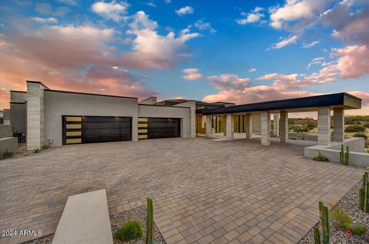 Just completed and ready for occupancy! 

Located in the highly coveted Troon area of North Scottsdale, in the exclusive luxury gated community of Cantabrica Estates, award winning architect Craig Wickersham, in collaboration with luxury home builder DWD Homes, has given careful consideration to the design and layout of this newly built home to create a striking modern silhouette set against the dramatic high Sonoran Desert landscape that maximizes views and privacy.

From pristine, design-forward finishes to vast expanses of glass that usher in the Arizona sunshine, the uniquely designed interior blends contemporary elegance with touches of warming finishes.

The main house offers 6494 square feet with 4 bedrooms, 4 full bathrooms and 2 half baths. The The great room, with its floor to ceiling automated and pocketing glass doors by Fleetwood, showcases direct views of Troon Mountain.  Flowing into the formal dining area, highlighted by a glassed front wine room and opening to a private patio area, guests will enjoy views of the Mazatzal Mountain range to the east, in addition to views of Troon Mountain to the west.  

For more relaxed entertaining, the casual dining area offers a bar area with four refrigerated beverage drawers, a Scottsman ice maker, and floor to ceiling, corner opening, glass doors that give access to the outdoor kitchen and patio areas. Along with a chef inspired kitchen, for both additional storage and use as a service kitchen, the architect added a Butler's Pantry with dishwasher, sink and refrigerator.  Additional rooms include an office, the wine room that holds approximately 700 bottles of your favorite wines, a large entertainment/media room with direct access to the outdoor area, and a gym with cork flooring and its own private patio.

The guest house has 1805 square feet with an expansive upper balcony to enjoy the surrounding mountain views, two ensuite bedrooms, a full size kitchen, very large separate living room, and a laundry room, giving a total of 8299 square feet to this home.

Highlighted are 6.5 oversized garage spaces with room to add 2 additional garages, if needed.

For those with a discerning taste in creativity, artistry and
fine materials, this residence harmoniously balances its
contemporary design with timeless earthy textures and
soothing hues to create a serene environment.

Along with showcasing the latest in efficiencies and technology,
designer selected expanses of Eurostyle Rift cut Walnut and French White Oak cabinetry in the chef's kitchen and throughout the home are highlighted. Finishes and fixtures include top of the line kitchen appliances like Wolf, SubZero and Miele. Dornbracht,
La Cava, Toto and Waterstone are a few examples of
plumbing fixtures. Along with large format ratified
limestone porcelain tile flooring and various Quartzite counter tops, extraordinary decorative lighting by Holly Hunt, Hammerton Forge & others is featured.

An abundance of natural sunlight filters throughout the home with Fleetwood's system of windows and the retractable glass door system in the main living space that opens to patios. With the doors and walls of glass throughout the home, there is a wonderful and seamless emersion between the indoor and outdoor spaces.

The outdoor living areas provide entertaining drama. Enhanced by views of Troon Mountain and the McDowell Mountain range, the expansive under cover patio with its outdoor kitchen, the pool and spa, and the large ramada with its multiple areas for seating and dining, the fireplace and the oversized TV niche, all create a
wonderful outdoor lifestyle.

Looking beyond this incredible home with its many unique and quality driven details, you will see what makes it and Cantabrica Estates so special--the endless and pristine beauty of the area showcased by the surrounding McDowell and Mazatzal Mountain ranges, Troon Mountain and Sonoran Desert views.

While just a short distance from all the city has to offer, the community of Cantabrica Estates is about tranquility and open space. For outdoor activities, close by are miles and miles of scenic hiking, biking and horseback riding trails, lakes for boating and fishing, as well as many world class golf courses. 

Easy access to the 101 Freeway allows you to reach various destinations around the valley quickly. Phoenix Sky Harbor can be reached in approximated 35 minutes and Scottsdale's private airport is about a 20 minute ride.  While there are many outstanding doctors, clinics and hospitals in the valley, The Mayo Clinic is also a short drive away.   

Looking for more? Scottsdale is known for its art and culture and offers an incredible mix of museums, shopping, restaurants, galleries and nightlife, along with a wide range of performing arts and special events such as baseball's spring training, Barrett-Jackson car auction, the Arabian horse show and the Waste Management Phoenix Open Golf Tournament.

Click on "Documents" tab for additional information about this home.