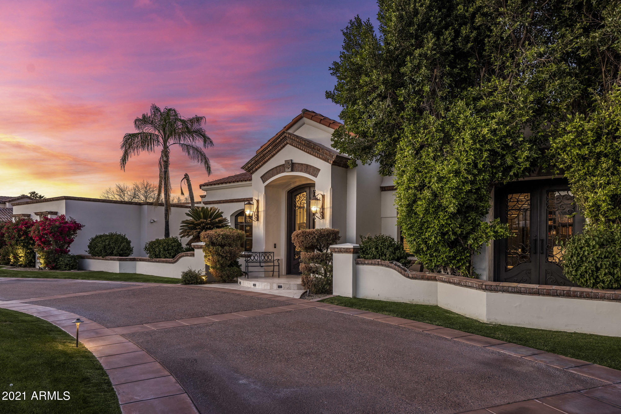 This gorgeous Paradise Valley residence originally built by Cal Christiansen is loaded with great taste and upscale finishes, starting with the gracious entry and continuing throughout the entire sprawling estate. The exceptional kitchen has double islands, double dishwashers and plenty of space for more than one aspiring chef, the living rooms are spacious and full of natural sunlight, both with soaring ceilings and custom fireplaces, the private office has impeccable custom millwork, the media room has a huge viewing screen, movie seating, and a full wet bar, and all of the bedrooms are perfect, including a dream worthy master retreat with another fireplace and seating area, and flawless master bath. The master bath opens out to a lovely relaxation patio offering a beautiful, serene space. Wood floors, exposed wood beams, marble surfaces, custom doors and windows, home automation system, and a temperature controlled wine room top the list of special features in the home, and the grounds are exquisite with a saltwater pool with heater and chiller, spa, tennis court with lighting for night play, ramada with built-in barbecue and sink, huge covered patio providing a fantastic outdoor living room, and expansive lush greenery. This pristine home is located in the heart of Paradise Valley surrounded by other estate properties and is ready for the next family to make it their own!