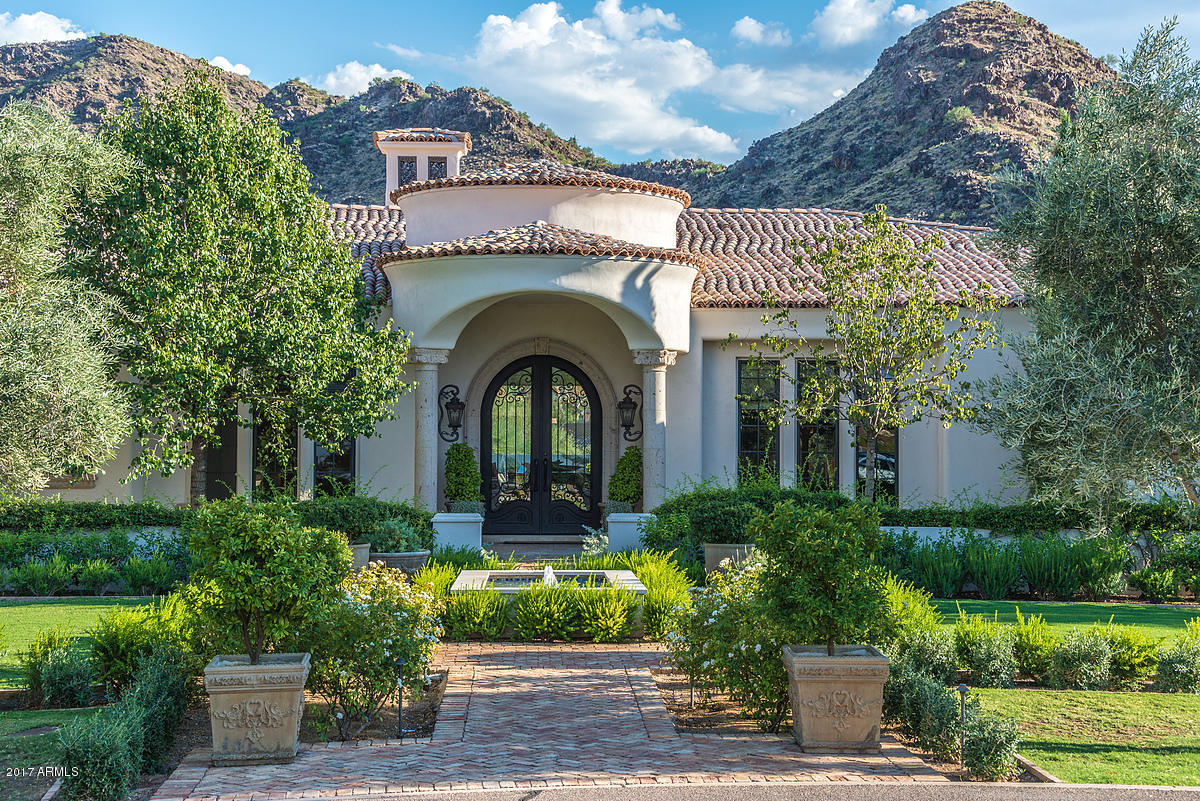 Exceptional classic Santa Barbara with extreme quality, 10 inch travertine moldings thruout---walk in 
Wine Vault- kitchen family room with 10 foot automated pocket sliding glass walls radius glass viewing windows, newly installed white quartsite counters oversized bedroom suites, second family area or study sectioin off the spectacular three bedroom guest-children's wing--large exercise or second office area -----Presidential office off the Master wing with an additional bedroom suite world class landscaped with huge mature trees and a fabulous pool, spa, and outdoor fireplace---4 car epoxy sealed garage floor and its own electronically gated motor court Extreme quality thru-out and a Mummy Mountain view that sits in the yard