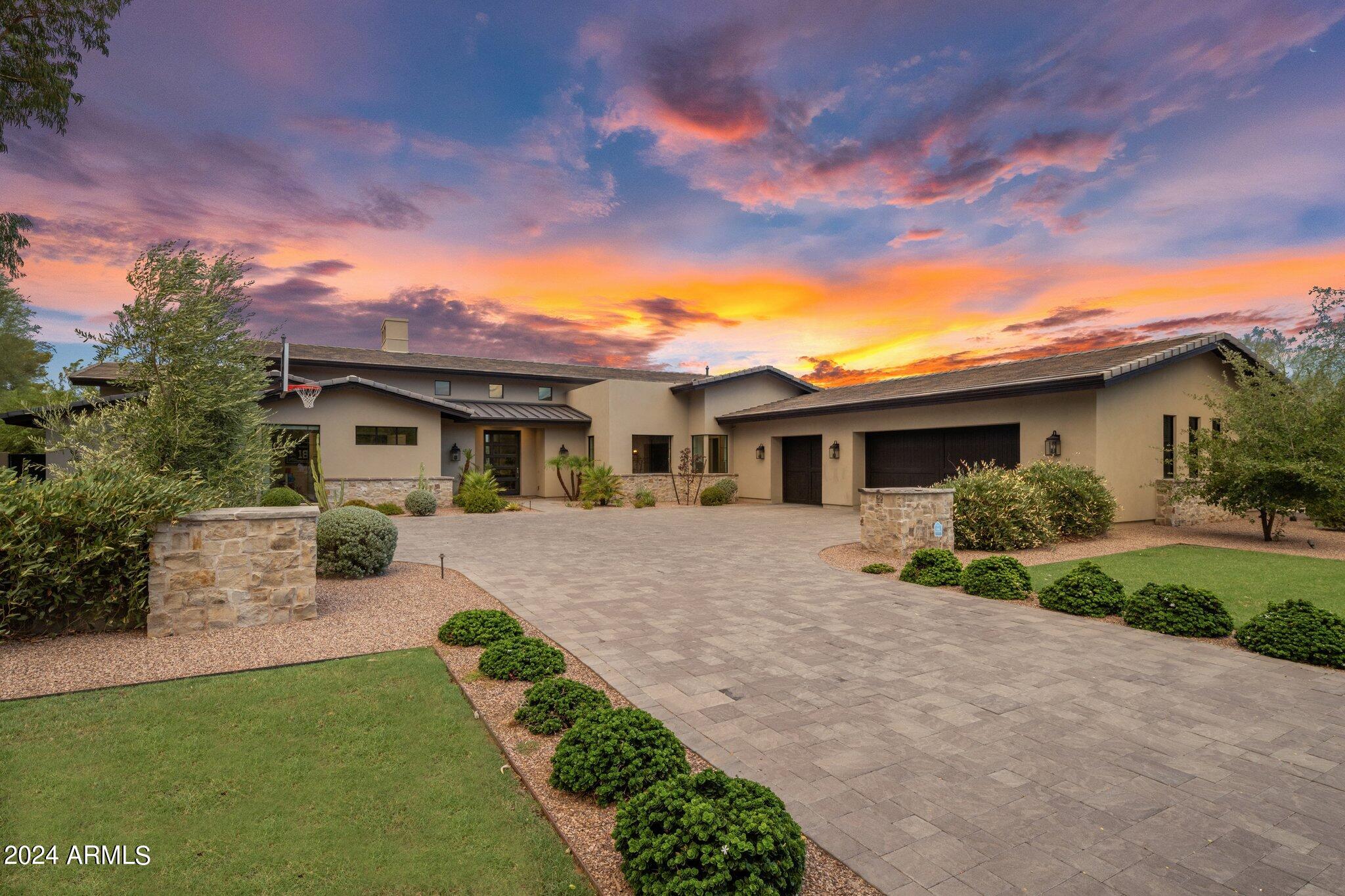 This custom Cactus Corridor estate impeccably blends luxury with functionality. Nestled on an impressive 1+ acre cul de sac street with no HOA, this transitional-style masterpiece, completed in 2017, offers stunning curb appeal and an expansive, open floor plan with large-scale living areas that connect seamlessly for entertaining and your family gatherings.  Equipped with a state-of-the-art Smart Home Control 4 System, you can effortlessly monitor music and TVs settings to suit your lifestyle.  The gourmet kitchen is a chef's dream, boasting high-end Thermador appliances, a stunning combination of quartz countertop materials, two large islands, a fruit sink, walk-in pantry, deluxe butler's pantry, and thoughtfully designed custom cabinetry throughout for optimal organization. Family room has 16-foot soaring ceilings, 20 ft. & 8 ft. sliding pocket doors, an 8-foot linear fireplace, and a floor-to-ceiling accent wall. Formal dining room includes a bar niche with beverage refrigerator, sink, and wine glass display. The primary suite is a luxurious retreat featuring a spa-style bathroom with a freestanding tub, an oversized shower with body shower heads and a rainfall showerhead, and two separate closets complete with an additional washer and dryer. Adjacent to the master suite is a spacious office with floor-to-ceiling windows and a walk-in closet. All 4 secondary bedrooms are en-suites with custom walk-in closets, providing ample privacy and comfort.  Additional highlights include a large laundry and utility room, a drop zone with shelving leading from the garage. Automated blinds throughout the home.  3.5 extended car garage with an epoxy floor. The resort-style backyard is an entertainer's paradise, featuring a sparkling swimming pool and spa, spacious patios, and an outdoor living room complete with a covered seating area and bar/BBQ island.  The expansive lot, with lush grass and sprawling travertine-tiled patio and pool area, brings a resort feel right to you. There's plenty of space to add a guest retreat or a sport pickleball court. This home puts the "fun" in functional and perfectly blends tranquility and modern sophistication in one of Scottsdale's most sought-after neighborhoods. Conveniently located near premier shopping, dining, and entertainment destinations and just minutes from the 101 freeway. and less than 10 minutes from Scottsdale HonorHealth and the Mayo Clinic. Cactus Corridor is desired for its easy access to shopping, hiking and bike trails, and all the amenities Scottsdale has to offer. This property offers the ideal balance of privacy and accessibility. With its stunning design and prime location, your dream home awaits and is ready for you to move right in.

Refer to supplement for more details.