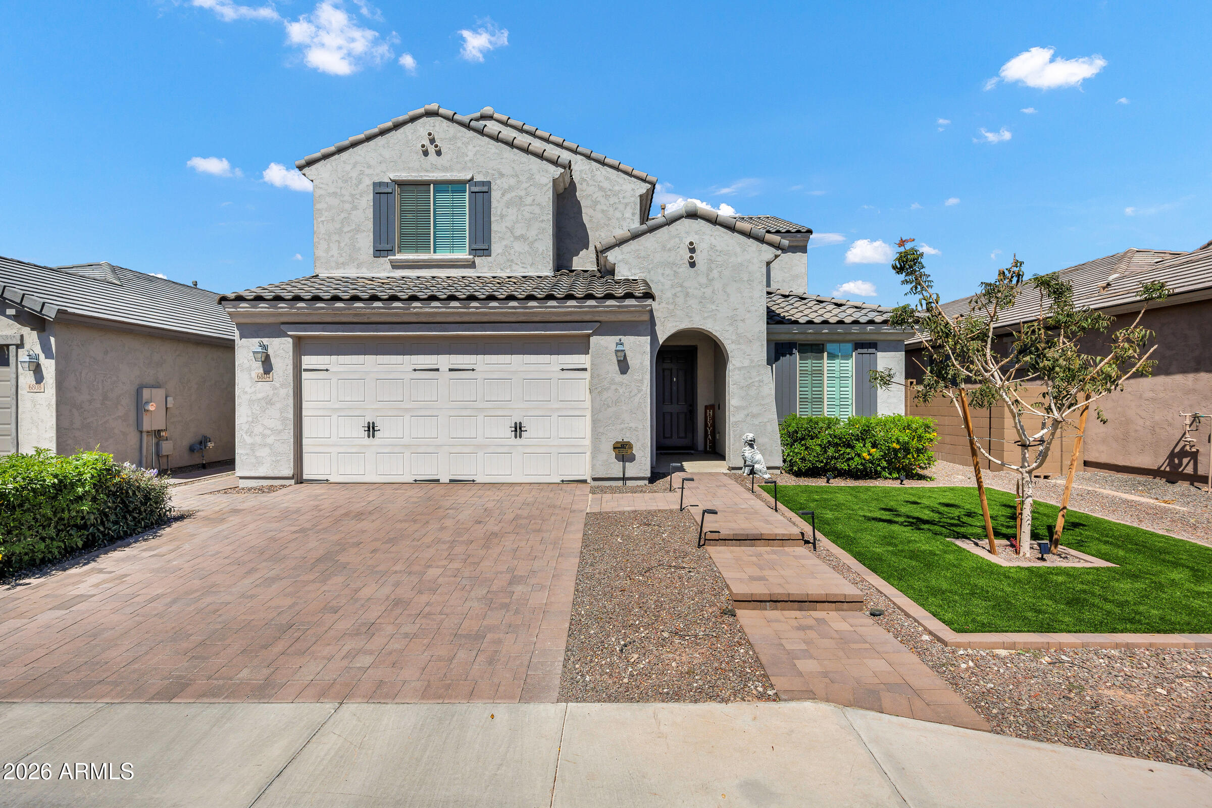 Welcome to this stunning 6 bed + loft / 5 bath Pulte home built in 2023 in the gated community of McClellan Ranch. Offering the feel of new construction without the wait, this move-in-ready home features high-end finishes, thoughtful upgrades, and a modern, neutral palette designed to impress from the moment you walk in. The front yard features low-maintenance artificial turf, enhancing curb appeal while keeping upkeep simple.

Step inside to soaring two-story ceilings, expansive open-concept living spaces, and abundant natural light. The great room flows seamlessly into the chef's kitchen, creating the perfect setup for entertaining. The kitchen features granite countertops, a large center island with breakfast bar seating, designer tile backsplash, a gas cooktop with hood, stainless steel appliances, and a walk-in pantry.

Throughout the home, you'll find luxury vinyl plank flooring, tile, and plush carpet in the right places, along with designer lighting and ceiling fans that elevate both style and comfort.

The spacious downstairs primary suite offers a true retreat with dual vanities, a walk-in shower with bench seating and dual showerheads, including a rainfall feature, a private toilet room, and a generous walk-in closet. Two additional bedrooms are conveniently located on the main level.

Upstairs, a versatile loft provides a flexible living space ideal for a media room, home office, or game room. Three additional bedrooms complete the second level, including one with its own ensuite bath.

The backyard is designed for Arizona living and entertaining, featuring a covered patio, custom gazebo, fire pit, pavered seating areas, a grass lawn, and accent lighting that creates an inviting atmosphere for entertaining guests at night.

Additional highlights include a downstairs laundry room with extensive cabinetry, a tankless water heater, a water softener, and a 2-car garage with overhead storage racks.

Located in the gated community of McClellan Ranch, residents enjoy a quieter lifestyle in the South Mountain corridor, with convenient access to hiking and biking trails, scenic desert landscapes, and quick connectivity to Downtown Phoenix, Sky Harbor Airport, and major freeways. This is the perfect blend of newer construction, privacy, and accessibility, making this one of Laveen's most desirable communities.