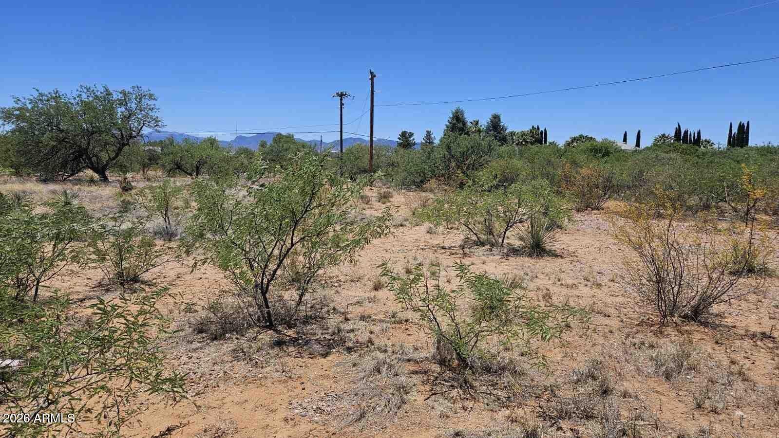 This property is being sold via online auction. Level residential-use parcel in Huachuca City with mountain views and a rural Southern Arizona setting. The appraisal reports the parcel contains approximately 27,966 sq. ft., with electric and water at or near the lot line and septic required. Convenient location near Sierra Vista, Fort Huachuca, highway access, Kartchner Caverns, and outdoor recreation. Property is being sold as-is. Buyer to verify access, utilities, zoning, building requirements, flood zone, septic feasibility, and all connection costs during due diligence.