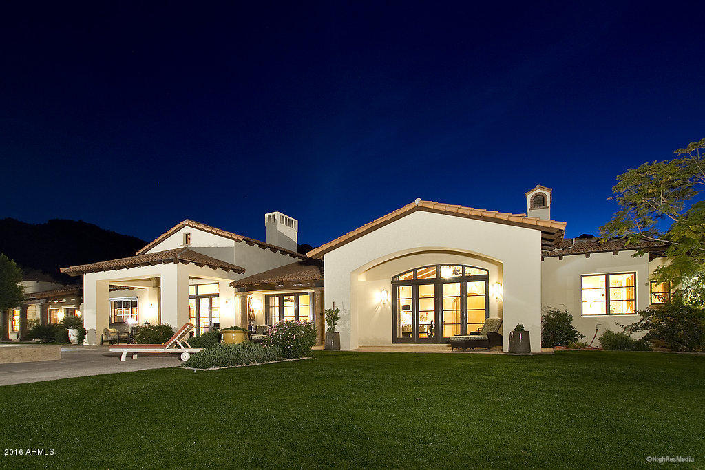 This timeless and charming Mediterranean 6 bedroom 8,238 sq ft home, including a full guest house, has lovely Mummy Mtn, McDowell and Pinnacle Peak views from its flat, slightly elevated lot. Beautiful distinctive finishes include hand-hewn hickory and imported stone flooring, pitched wood ceilings; some with trusses + massive wood ceiling beams,graceful scalloped walk thru-room entries and multiple charming French doors to the outdoor grounds. A beautiful chef’s kitchen opens to the main family rm which opens to a second family rm next to 3 ensuite bedrms. Perfect for relaxing + entertaining it features a library, exercise room, media room, wine room and computerized electronic system. Enjoy the infinity pool with baja shelf + spa,large grass areas, multiple courtyards and fabulous views!