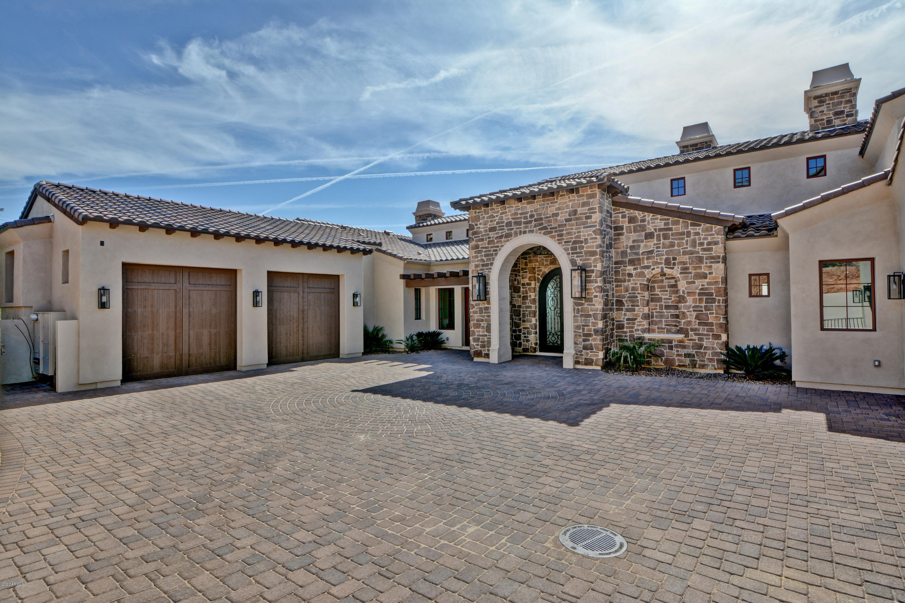 Timeless design and elegant architecture make this stunning brand new custom home in Firerock Country Club a one of a kind masterpiece. Please see 3 page upgrade list in documents. Take in the breathtaking mountain and city light views easily from the gourmet chef's kitchen/casual living room that simply flows into the outdoor kitchen/entertainment area with sparkling pool and spa. Indoor/outdoor living design at its finest! Home is wired for  smart home technology which will allow you to control everything down to the oven right from your phone. Chef's kitchen includes a enormous butler's pantry, Thermador appliances, 6 burner gas stove with griddle and custom chandeliers that will delight any guest. Entertain your guests with the giant game room, including a kitchenette/bar with kegerator, ice maker, soaring marble fireplace and plenty of space for a pool table or multiple game tables. Car lover's will be excited about the 9 and 10 foot garage doors, J Shaft for car lifts, reinforced concrete, 220W and climate controlled storage rooms. Some special extra's include a large wine room, craft area/dog washing station added to oversized laundry room, a hidden loft to delight a child's imagination, mother in law quarters with kitchenette, en suite bathrooms in each guest room and custom lighting chosen for each space in the home, down to the soft glow that highlights the enormous master wing; including massive closet, his/hers water closet, soaker tub, en suite fireplace, sliding patio door that pushes into the wall and opens up onto a private master patio with a fireplace and additional outside bathroom. 10 minutes away from Basis Scottsdale.  Every detail for luxury living! Schedule your private showing and see what Firerock and Fountain Hills has to offer!