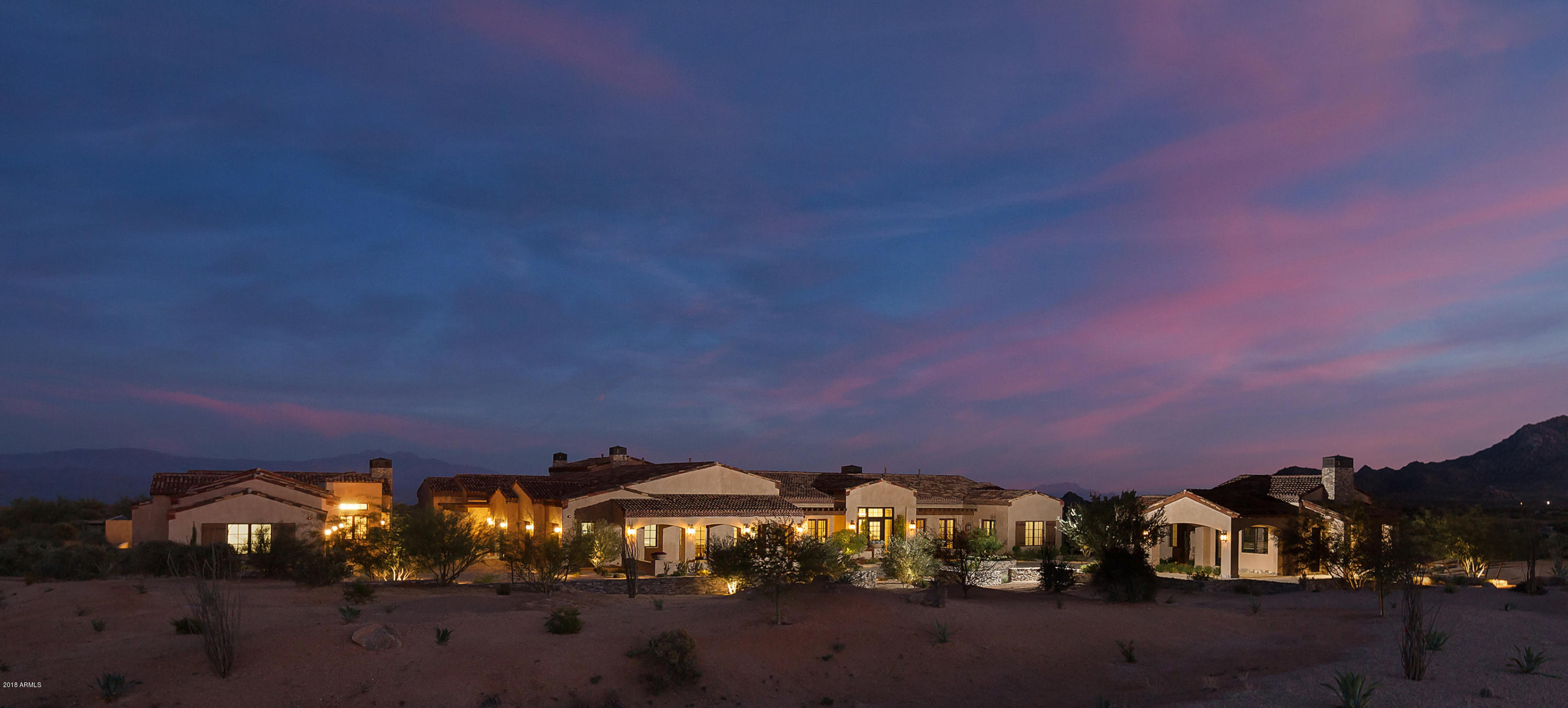 This newly built home is perfect for any multi-generational family needs or the corporate executive looking for a retreat from their hectic daily schedule. Along with the 7317 square foot main house located in the very private gated community of Cantabrica Estates in the Troon area of North Scottsdale, highlighted are also a two bedroom guest house with 1165 square feet and a smaller guest house with 793 square feet.

Enjoy easy and quick access to all the lifestyle amenities Scottsdale is known for, but retreat at the end of the day to this unique home located in a community that really is one of the last of it's kind in North Scottsdale. Enjoy the hushed desert sounds of nature and the serenity created by unimpeded views of the high Sonoran Desert.

Architecturally inspired by the Architecturally inspired by the timelessness of rural Mediterranean estates while offering all the casual luxury that is timeless, warm, comfortable and inviting. It readily accommodates family activities and entertaining on any scale.

On almost 2.5 acres, careful consideration to timeless detail enhance the well thought out floor plan of the 7317 sq. ft. main house with its French Limestone floors, stacked & Canterra stone fireplaces, varied ceiling styles, open flowing floor plan and 6 car garage, with room for more.

An underground wine cellar is set up for casual entertaining. Perfect for family members or guests is the 1165 sq. ft. two bedroom guest house and a one bedroom 793 sq. ft. carriage house, both with outdoor covered verandas. Multiple seating areas, and an open air pool house with fireplace, stone floors, wood beamed ceiling and the kitchen and dining spaces, all add to an indoor and outdoor lifestyle that flows seamlessly. Every expectation is fulfilled. Absolute Tranquility in an inspired setting.


Read on for more in depth description of this home:
.

This magnificent farm house style Mediterranean estate is the result of the vision and the superb craftsmanship of award winning builder, LaBlonde Homes. With breathtaking views of Arizona's Sonoran Desert, along with incredible and expansive views of the McDowell and Mazatzal Mountains, Four Peaks, Troon Mountain and Pinnacle Peak, this home is the epitome of casual luxury and readily accommodates family activities and entertaining on any scale.

Quality of construction and careful consideration to timeless detail enhance the well thought out floor plan of this home. Offering 7317 square feet in the main house, a 2-bedroom guest house with 1165 square feet and the 1 bedroom carriage house with 793 square feet. Blending the indoor and outdoor living seamlessly, every expectation is fulfilled with generous sized rooms and luxurious, relaxed livability.

The main house offers a very timeless and comfortable lifestyle. Details emphasizing the classical European character of this home include stone covered circular drive, dry-stacked stone around the exterior of the home, interior floors finished with French Limestone and hand-hewn, random wire brushed wide plank wood, stacked stone and Canterra stone fireplaces, and a variety of ceiling styles, including the multi-barreled, brick faced kitchen ceiling, the open web, wood beamed trusses in the Master, and the wood trimmed multi-box ceiling in the great room.

The warm, and inviting luxurious master suite offers its own stacked stone fireplace and massive wall of windows, allowing for expansive mountain views. Additionally, there are 3 over-sized guest bedrooms in the main house, all ensuite, and a large study or 5th bedroom with bathroom, walk-in closet and direct access to the front drive.

Other rooms in the main house include the library--so inviting with its classic architectural mill-worked walls and wood beamed ceiling--an exercise area, and the living room, opening directly to the patio and outdoor areas, showcasing spectacular mountain views.

Add to this a true gourmet and entertainer's kitchen showcased by the multi-barreled, brick lined ceiling and opening directly to the family room. This luxurious, European farm style kitchen has been designed to include two very large pantries, one for storage and the other a "Butler's Pantry," top of the line appliances and double islands.

Along with being open to the kitchen, the family room embraces you with its warm and cozy atmosphere. French Lime stone floors, the wood trimmed, multi-boxed ceiling, a stacked stone fireplace and very large, pub style bar with its custom made zinc bar top, establish the atmosphere and make this a very special part of the home to enjoy with family and friends. A wonderful surprise is the basement level wine cellar with stone covered walls and seating areas, perfect for intimate gatherings.

Perfect for guests, extended family or live-in help is the detached 2 bedroom guest house with living and kitchen areas and a detached 1 bedroom carriage house, also with a living and kitchen area.

Step outside this incredible home with its many unique and quality driven details and you will see what makes this home and Cantabrica Estates so special--the endless and pristine beauty of the area and the McDowell and Mazatzal Mountain, Troon Mountain, Pinnacle Peak and Sonoran Desert views.

As a personal retreat, or for entertaining, the outdoor areas of this very distinctive home offer an inspired living space. Framed by mountain views and lush desert landscape, enjoy sunny skies while lounging in the double negative edged pool or relax in the spa or gather around the fire-pit in the evening and gaze at the brilliant star lighted sky. With plenty of room for additional outdoor activities to be added, perhaps you would like your own chipping and putting greens, a Bocce Ball court, or an intimate and private reflection garden?

For outdoor entertaining, dine under the many covered patios or in the open air pool house with its antiqued bricked floor, open wood beam ceiling, built in kitchen, stone fireplace, and also offering a private bathroom with shower.

While just a short distance from all the city has to offer, Cantabrica Estates is about tranquility and open space. For outdoor activities, close by are miles and miles of scenic hiking, biking and horseback riding trails, lakes for boating and fishing, as well as many world class golf courses.

Looking for more? Scottsdale is known for its art and culture and offers an incredible mix of museums, shopping, restaurants, galleries and nightlife, along with a wide range of performing arts. Special events to enjoy include baseball's spring training, Barrett-Jackson car auction, the Arabian horse show and the Waste Management Phoenix Open Golf Tournament.

Click on "Documents" tab for additional information about this home.