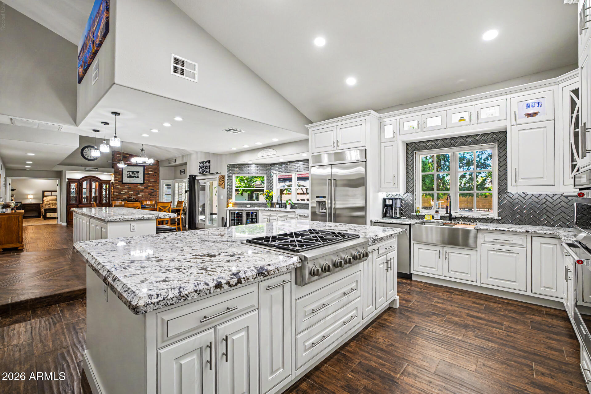Separate guest house, RV GARAGES, 30k gallon diving pool-Experience the perfect blend of luxury, functionality, and resort-style living in this one-of-a-kind custom estate. Designed for both everyday comfort and entertaining, the beautifully remodeled open-concept kitchen is the heart of the home, featuring expansive workspace, premium finishes, and seamless flow into the spacious living and dining areas.
The single-level main residence offers 3 bedrooms, 2.5 bathrooms, and an exceptional floor plan filled with natural light. Car enthusiasts, hobbyists, and RV owners will appreciate the incredible garage and shop space, including an attached 5-car garage (configured as a 3-car garage plus an oversized RV or large truck bay) and a separate double-bay RV workshop with lift & oil change pit. With room for up to 10 covered vehicles, this property is truly a rare find.
Guests or extended family will love the fully detached casita, complete with its own full kitchen featuring stainless steel gas appliances, private laundry, a remodeled walk-in shower, and a secluded patio--perfect for multigenerational living, visitors, or rental opportunities.
Step outside into your own private oasis. Mature shade trees, lush green lawns, and abundant landscaping create a setting that feels worlds away from the Arizona desert. Enjoy year-round outdoor living with commercial-grade misting systems, a BBQ ramada, an impressive in-ground smoker pit, and a spectacular infinity-edge diving pool and spa with a diving deck.
A grand circular driveway with a porte-cochère provides an elegant arrival and enhances the estate's impressive curb appeal.
This extraordinary property offers a combination of luxury, privacy, and unmatched garage capacity that is rarely available.

**Owner/Agent.**