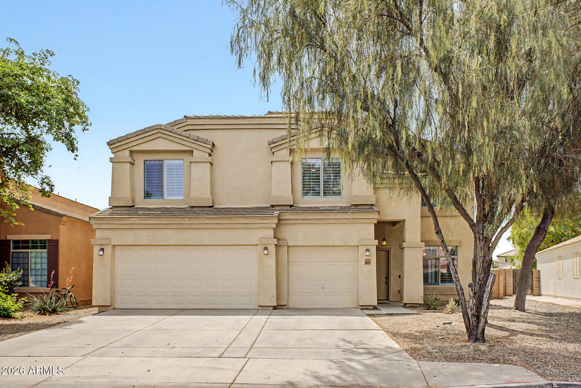 Spacious 6-bedroom home with loft and 3-car garage located in Maricopa. Interior features include tile flooring in main living areas, plantation shutters, and a neutral color palette. The open great room includes sliding doors providing access to the backyard. Kitchen offers a large island with breakfast bar and ample cabinet and counter space. Upstairs loft provides additional flexible living area. Primary suite includes dual sinks, walk-in closet, and private bath. Backyard features a full-length covered patio and space for outdoor use. Conveniently located near parks, schools, shopping, and dining.