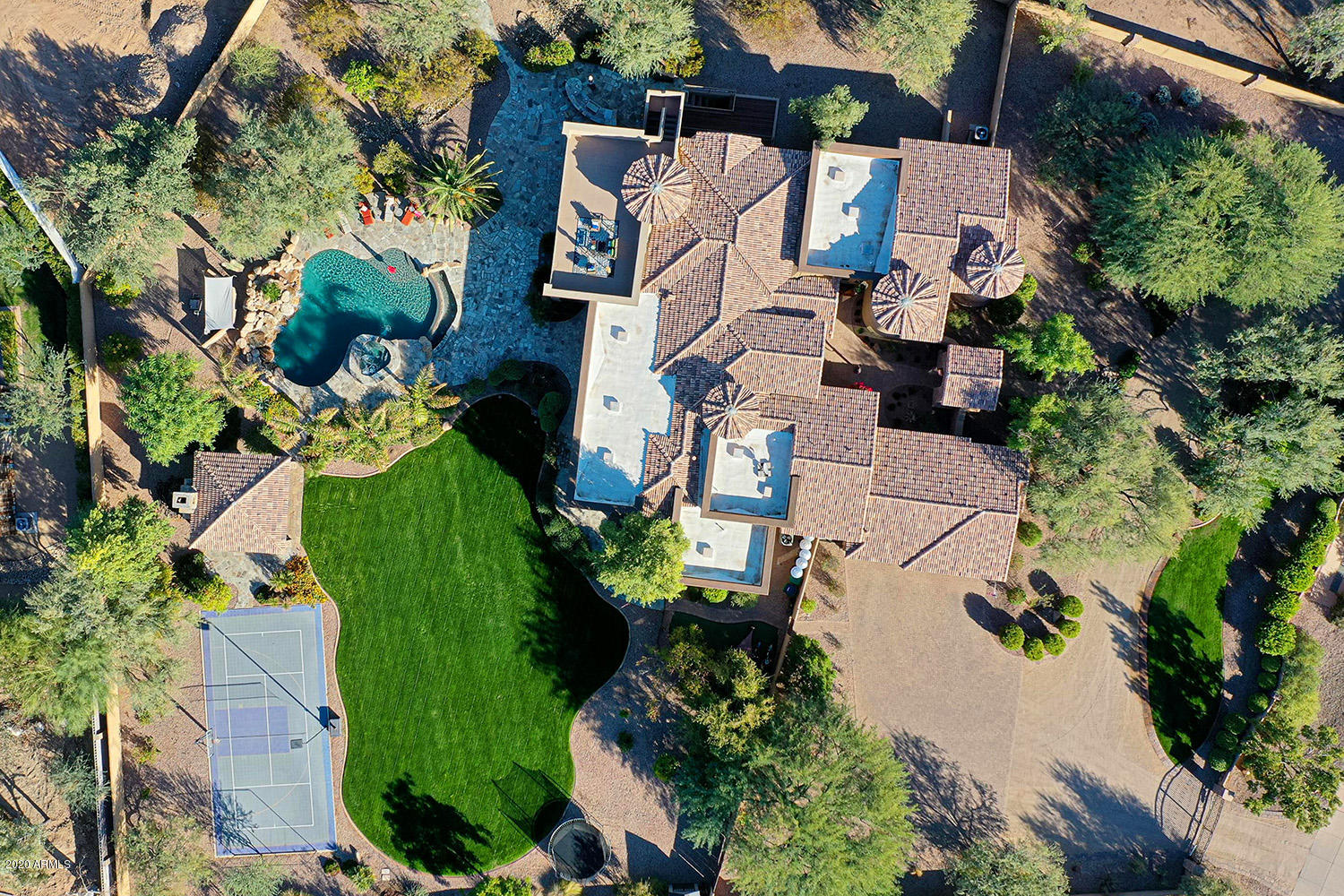 EXQUISITE ENTERTAINER'S ESTATE. Custom built on a premium 1.59 ACRE Paradise Valley homesite, this stunning Tuscan-inspired home wows with fine finishes, mountain views and a full walkout basement. The split plan's masterful main level is host to formal living spaces and an executive's office. A chef's dream, the gourmet island kitchen features slab granite, premier stainless appliances, butler's pantry and so much more. Relaxing master suite. All bedrooms boast en-suite bathrooms and walk-in closets. A tiered home theater, bonus room and well-appointed wet bar and 900+ bottle wine cellar await you downstairs (w/exterior access). Expansive patios stretch out to meet the pebble-finish pool, spa, ramada w/fireplace, built-in BBQ, lawn and sport court. Savor sunsets from the rooftop deck. Additional Amenities & Features
5 BD  |  7 BA  |  7,466 SF  | 1.59 ACRES (69,523 SF)
3-Car Garage: Side Entry, Paver Motorcourt, Epoxy Floor, Built-In Cabinets, Sink
Custom Constructed in 2005
Barreto Subdivision
Convenient Canal Trail Access
Preferred North/South Exposure
Dual Gated Entries
Semi-Circle Front Drive
Private Gated Front Courtyard
Custom Iron-And-Glass Entry Door
Exterior Split-Stone Accents
Designer Architectural Details
Eat-In Kitchen: Pendant Lighting, Dual Sinks, Built-In Fridge, Built-In Freezer, Walk-In Pantry, Tiled Backsplash, Hardwood Cherry Cabinetry, Pot Filler, Wall Oven, Built-In Microwave, Dacor 6-Burner Gas Range, Reverse Osmosis
Bay-Window Breakfast Area
Master Suite: Private Exit, Sitting Room, Exercise Room, Fireplace, Walk-In Closet, Washer/Dryer Hookup, Tile-Surround Shower w/Rain Head, Jetted Soak Tub, Dual Vanities
Laundry Room: Cabinets, Dual Countertops, Sink
6 Gas Fireplaces (4 Interior / 2 Exterior)
Dual-Pane Windows
Recessed Tray Ceilings
Wet Bar: Raised Seating, Dishwasher, Built-In Microwave, Refrigerator 
Hardwood Floors & Plush Carpeting
Natural Travertine & Slate Stone Tile
Pre-Wired for Surround Sound
Owned Security System
Block Wall Fencing for Privacy
Front/Back Auto Watering System
Owned Water Softener 
Side Entrance to Back Yard
35,000 Gallon Pool: Heated, Salt Water, Beach Entry, Natural Rock Waterfall, Reverse Negative Edge
Heated Spillover Spa
Exterior Pool Bath & Outdoor Shower
Butt-Glass Windows (Master Suite & Living Room)
Built-In BBQ Island: Extra Burner, Fridge, Raised Seating
Flagstone Covered & Open-Air Patios
Firepit w/Seating
Central Vacuum