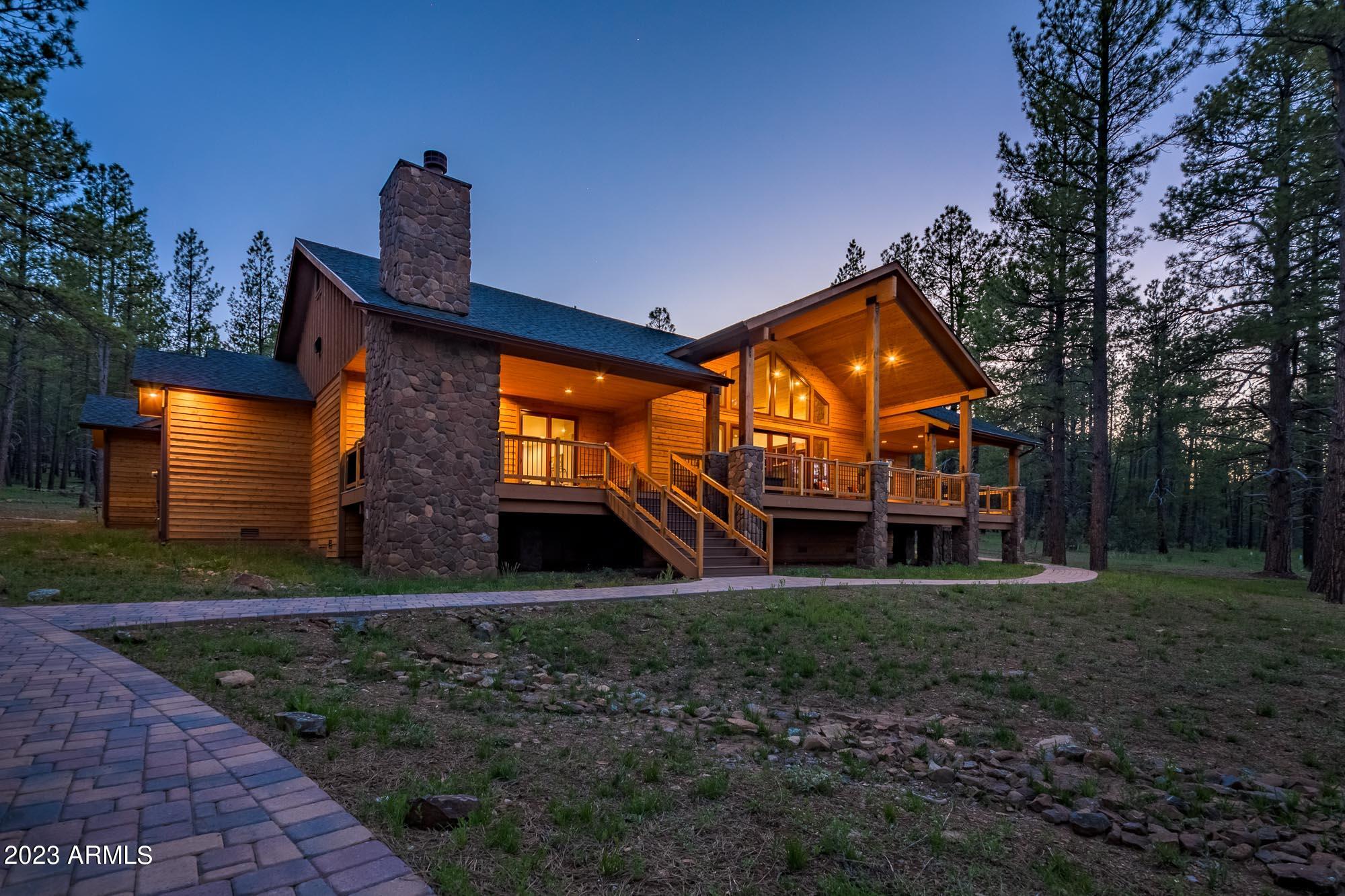 Step into LUXURY living in this STUNNING CUSTOM MOUNTAIN HOME in Foxboro Ranch Estates. This SINGLE LEVEL home & CASITA are 4,461 Sq Ft combined & sit on a 1.98 ACRE lot backing the National FOREST, offering PRIVACY and STUNNING VIEWS from the LARGE Paver COURTYARD or COVERED DECK. HIGH-END finishes throughout; sparkling GRANITE countertops with CHISELED edges that lend a nuance of RUSTIC charm, KNOTTY ALDERWOOD doors, cabinets and trim adding a touch of NATURAL BEAUTY & strength, COHESIVE fixtures, CHEFS KITCHEN with ample storage & HIGH-END appliances, 26FT VAULTED ceiling, INDOOR & OUTDOOR fireplaces. CASITA includes a FULL bath, Garage, Kitchenette & COVERED PATIO. Don't miss your chance to own this EXCEPTIONAL PROPERTY within 260 ACRES of Breathtaking Northern ARIZONA Landscape!
