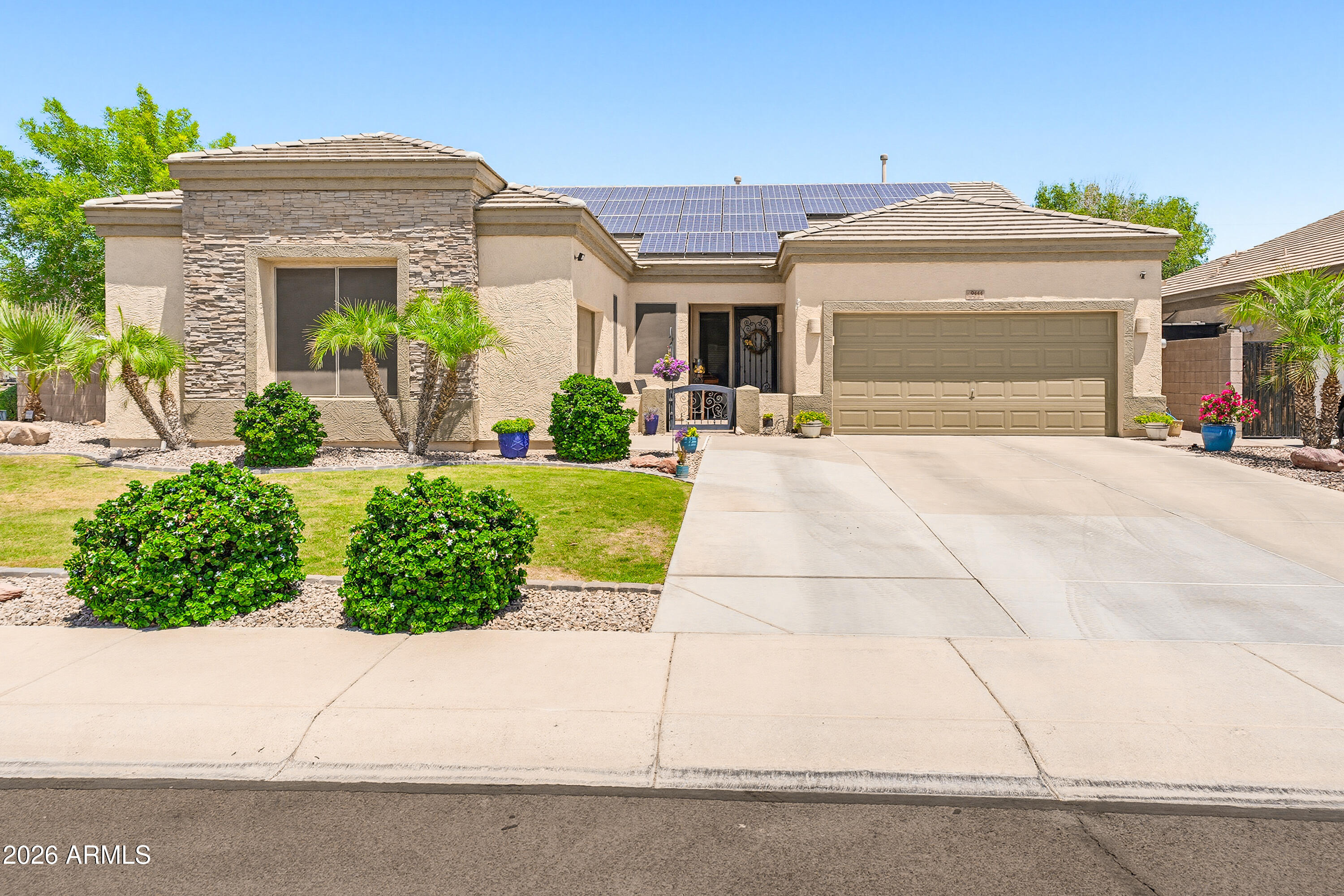 Extreme pride in ownership shines throughout this stunning 3-bedroom + DEN home on a desirable corner lot! From the manicured landscaping and inviting courtyard to the beautifully maintained interior, this home is truly move-in ready. Features include OWNED Solar with new inverter, 3-car garage, grand foyer, arched doorways, recessed lighting, and spacious living areas. The gourmet kitchen offers granite counters, large island, stainless steel appliances, walk-in pantry, designer backsplash, and beautiful cabinetry. Major upgrades include exterior paint (2025), AC units replaced (2023), and a brand-new pool deck (2025)! A rare opportunity to own a beautifully upgraded Arizona home with style, efficiency, and comfort! Adorable main suite has private backyard access & elegant ensuite w/large walk-in shower. Backyard oasis includes a covered patio, sparkling blue pool, built-in BBQ, & artificial turf. A must-see residence!
