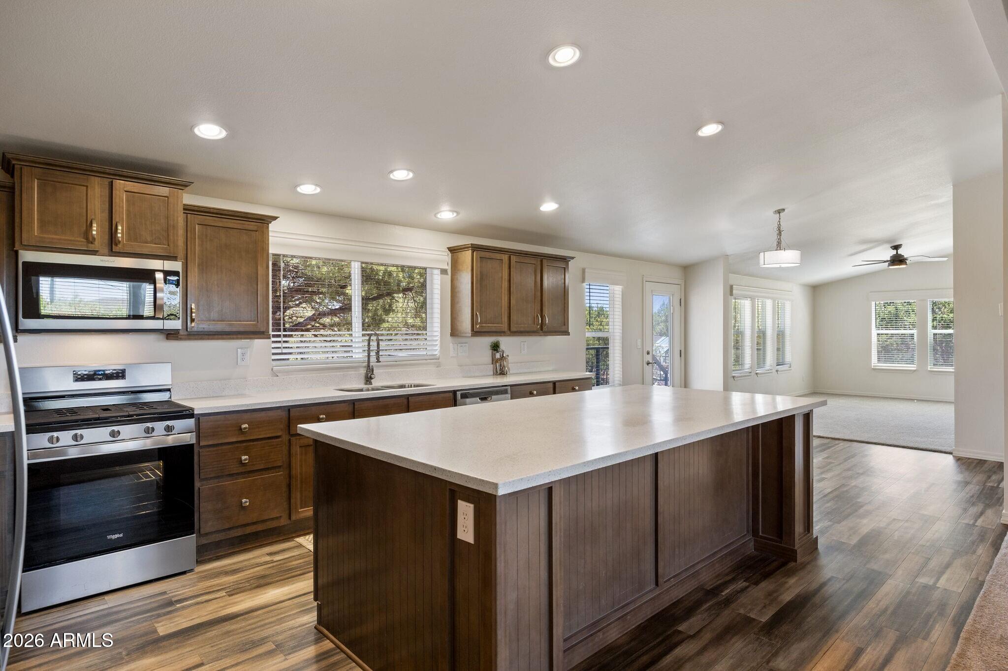 Exceptionally clean & lovingly cared for, this upgraded home is situated on over 2 acres with breathtaking mountain views & scenic views of Ortega Draw! This spacious 3 bed, 2 bath home offers both a living & family/bonus room, creating the perfect layout for everyday living or entertaining. The oversized 9' x 4 ½' kitchen island anchors the stunning kitchen featuring SS appliances, Corian counters, gas range, walk-in pantry & upgraded staggered cabinetry w/crown molding. Upgraded features to love - 2 x 6 construction, vaulted ceilings, modern lighting, ceiling fans, plush carpet & beautiful wood plank vinyl flooring.  Additional features include vinyl windows, rain gutters & inviting outdoor spaces with a large covered Trex front deck (25' x 16') & an open backyard Trex deck (24' x 12') designed to take in the incredible views. The property also includes his & her sheds/workshops, greenhouse, RV parking with water, septic access & wired for both 30 & 50 amp.  Additional improvements throughout make this home move-in ready & unforgettable!