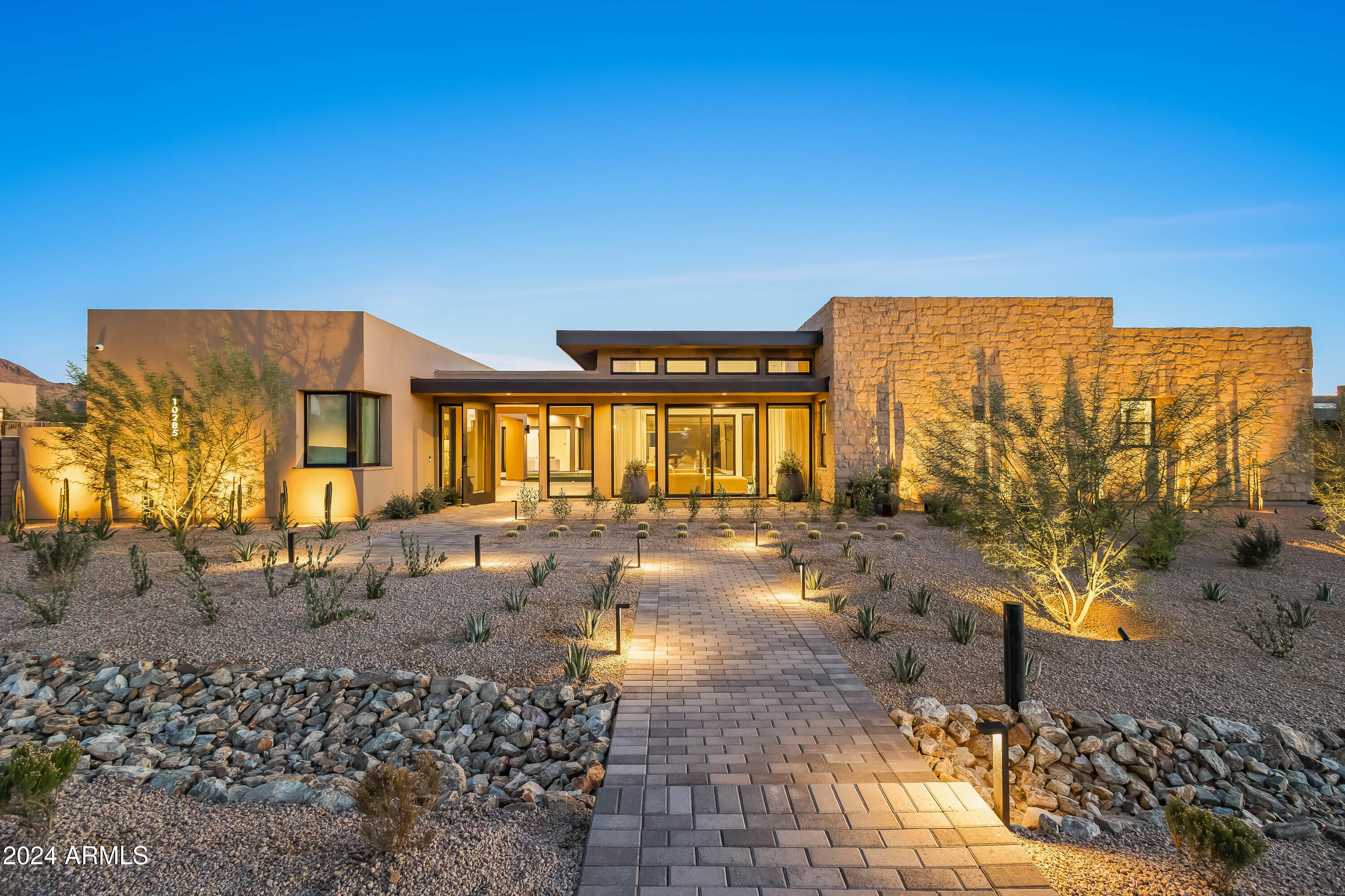 THE best lot in Skye View!  Exceptional 5,932 square foot modern dream home featuring beautifully landscaped desert gardens and a luxe resort-style backyard.  Breathtaking mountain and city light views in every direction!  Built in 2024, this prestigious N. Scottsdale modern contemporary home is just minutes away from McDowell Mountain Regional Park and Tonto National Forest, access to the 101 Fwy, Scottsdale Quarter, Kierland, and Promenade restaurants and shopping, and close to some of the top AZ golf courses including The Estancia Club, Troon North, Mirabel, and more.  With its distinctive architecture and award-winning contemporary design, the home was designed and built by Camelot Homes, boasting an unrivaled attention to detail. The open floor plan is perfect for entertaining, inviting the outdoors in. All the living spaces have direct access to the outdoor spaces which include a front entry portico, fully shaded outdoor living/ loggia with fire feature, dining on back patio, bonus room plus indoor bar with stacked telescoping doors, outdoor grill, and a dedicated loggia for the guest casita. The backyard is highlighted by breathtaking sunset views, custom heated pool with two Baja decks, water features, built-in planters, poolside seating area, separate spa, and lush artificial turf.
  
The home includes a dramatic front entry, well-appointed gourmet kitchen overlooking main living areas, 4 bedrooms, 4.5 bathrooms, office/ den, guest casita, and 4 car garage specialty space that can be used as a home gym or flex space. Additionally, the home boasts Rift Oak cabinetry throughout, honed Quartz countertops, large format Porcelain tile flooring, custom metal iron clad fireplace, Wolf| Sub-Zero appliances, temperature-controlled wine cellar, Zip Tap (instant chilled, instant hot, and sparkling water), Butler's Pantry, designer lighting and plumbing fixtures, elevated ceiling heights, glass detailing, Savant Audio Visual system, motorized designer window coverings in all rooms, security cameras, double stack laundry and LG styler garment refresher| drycleaner, Sonance landscape speakers, and specialty details throughout. 

The primary bedroom suite features a luxurious primary bath, custom cabinetry, designer lighting/ plumbing fixtures, porcelain tile flooring, dual vanities, expansive walk-in shower and soaking tub with telescoping door that opens to the backyard with mountain and city light views, and spacious his /hers walk-in closet. Soak in world-class views of Pinnacle Peak, Troon Mountain, and Desert Highlands from this custom-built home. This is one of the finest properties available on the luxury market!