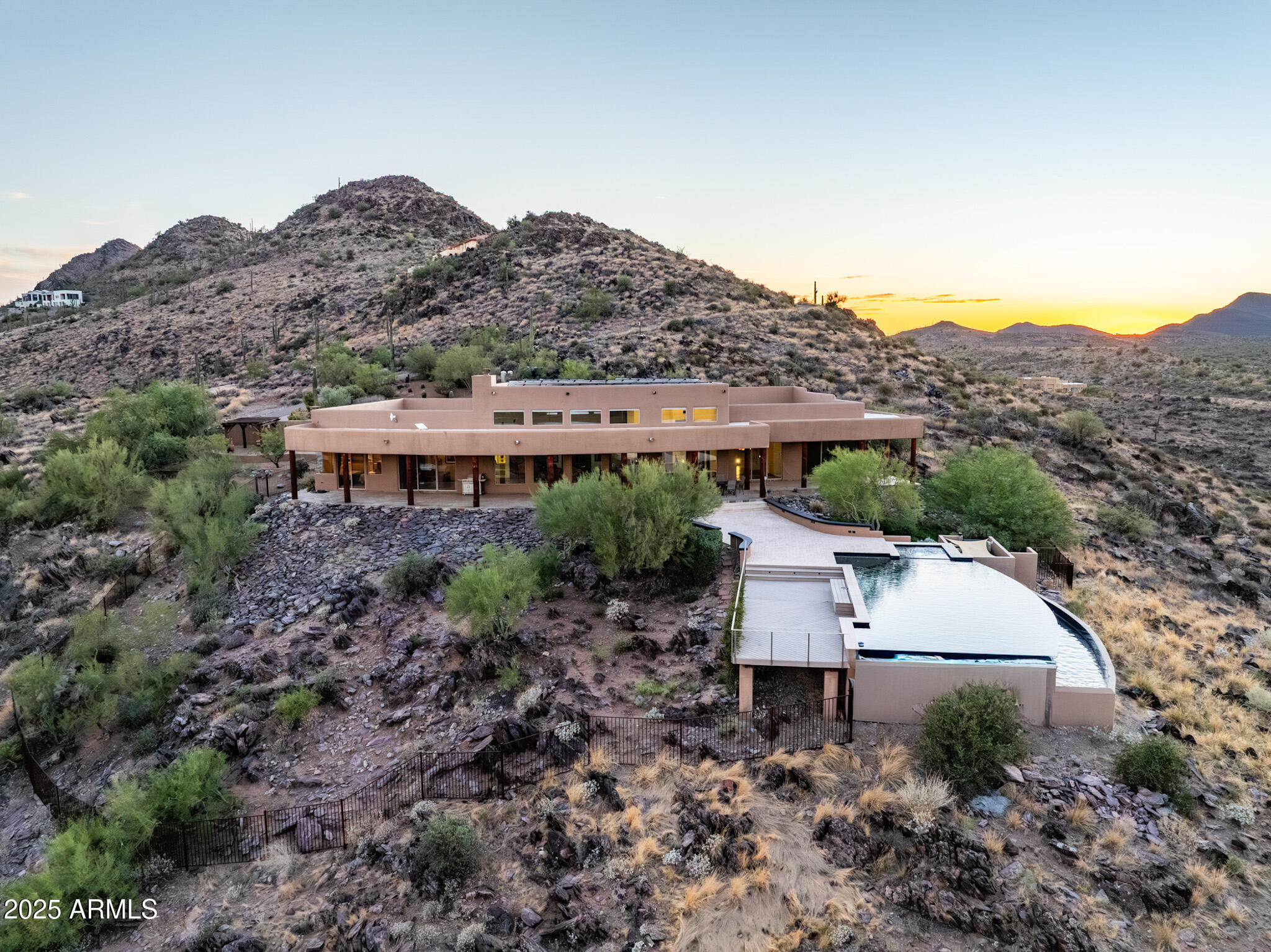 Perched on 5 private acres with stunning mountain views, this home captures Arizona living at its best. Soaring ceilings & expansive windows fill the open split floorplan with natural light, showcasing panoramic sunrises & sunsets. The owner's retreat has two large glass sliders that lead to the wrap-around patio and the most beautiful views of the natural desert. The master suite is set apart from a private wing which is complete with an office and 3 ensuite bedrooms. A pavered drive leads to plenty of guest parking, a courtyard entry & 3-car garage. Perfect for entertaining yet peaceful for everyday living, the back patio overlooks a fenced yard, elevated deck & infinity lap pool. Just minutes from the charm of Cave Creek, this retreat offers both convenience & tranquility.