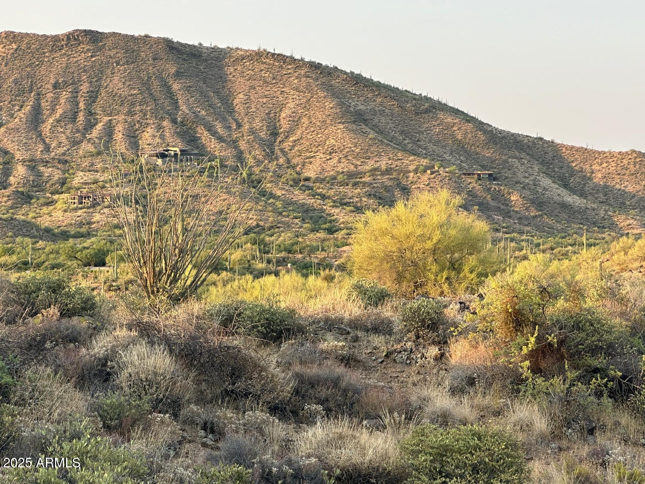 Unique 11 acre lot in Scottsdale.  Located in a quiet gated community with sweeping mountain, city light, and golf course views.  This rare lot offers unmatched private and complete building flexibility and includes water rights. 

Agent related to seller.