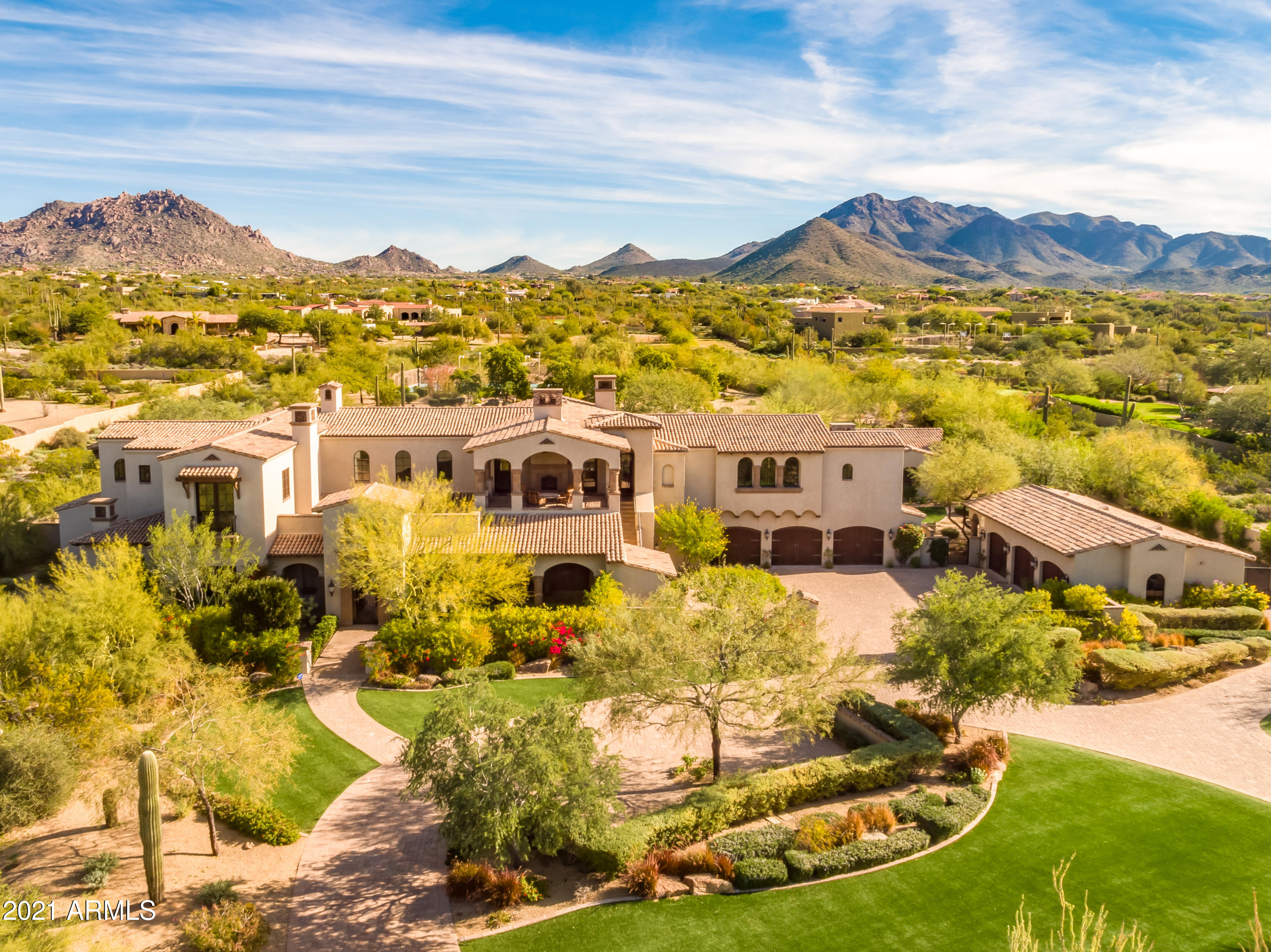 ***SPECTACULAR Calvis Wyant built North Scottsdale estate*** Located in the private Prado community between DC Ranch and Pinnacle Peak Rd, you are just steps away from chic restaurants, casual cafes and shopping while still being able to escape to your very own private resort-style sanctuary retreat. A Spanish Mediterranean masterpiece, this very special property pays tribute to its Spanish influences with a multitude of lower and upper level patios, imported stone columns, wood beams and elevator all centered around luxurious courtyards and nearly 4.3 acres of landscaped grounds truly meant to be shared and enjoyed The almost 11,000 square feet of living space begins with the approximately 9,400 square foot main house... made up of an exquisite master suite with sitting room, his & hers walk-in closets, oversized soaking tub and steam shower, 2 junior master bedrooms, 3 large ensuite bedrooms with bonus space and 6 car garage (3 are climate controlled). The separate guest house is approximately 1,282 square feet with a large front patio with views of Pinnacle Peak, two bedrooms, two full bathrooms, family room with fireplace, full kitchen and washer/dryer. An entertainer's paradise, the open kitchen with two center islands and commercial refrigeration in pantry opens up to a wonderful living space, casual dining area, butler's pantry and formal dining room with climate controlled wine cellar. The exterior estate grounds continue with private amenities including heated pool and spa, custom stone fountains, outdoor kitchen, verandah with swim-up bar, full-size lighted basketball or tennis sport court, putting green with bunkers, in-ground trampoline, fire pit area, low maintenance synthetic turf and seemingly endless walking paths. Shown by appointment, schedule your private tour of this not to be missed one-of-a-kind luxury estate today.