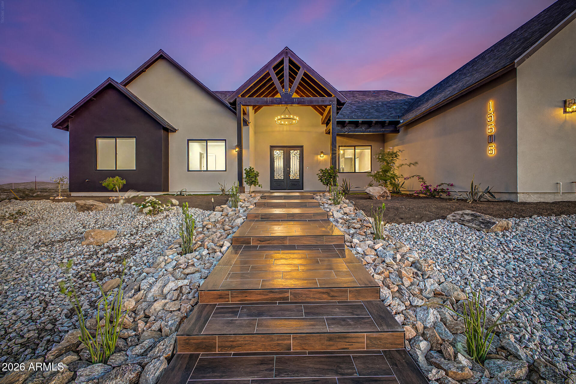 LUXURY DESERT LIVING on 1.24 acre. This stunning custom home offers breathtaking panoramic views of the surrounding mountains and city lights--perfectly blending peaceful desert living with modern comfort.
This beautifully designed residence features 4 spacious bedrooms, 3 bathrooms, and a custom 3-car garage, all with no HOA and horse privileges, giving you the freedom and space you've been looking for.
Step inside to an expansive open-concept layout highlighted by a chef-inspired kitchen with abundant cabinetry, a large center island, stainless steel appliances, and ample storage for all your culinary needs. The home also features a stylish entertainment center and dry bar, ideal for hosting and everyday enjoyment. The vaulted ceilings with decorative wood beams create a warm, rustic charm that perfectly complements the home's country-inspired design, while maintaining a modern, elegant feel throughout.
The primary suite is a true retreat, offering private access, a luxurious bathroom with a jetted soaking tub, dual sinks, bidet, and a sleek walk-in shower. The spacious walk-in closet is thoughtfully designed with built-in cabinetry and a center island for added convenience and organization. Each additional bedroom is generously sized and includes ceiling fans for comfort. One of the secondary bathrooms also features a bidet, and all bathrooms showcase beautiful tile work with glass shower enclosures.
Additional highlights include:
Farm-style light fixtures throughout
Epoxy-coated garage for durability and style
Inviting front porch with custom wood detailing that enhances the home's character and creates a welcoming entrance
Professionally designed desert landscaping
This one-of-a-kind property offers the perfect combination of custom craftsmanship, space, and unbeatable views--a rare opportunity to own a true desert gem.