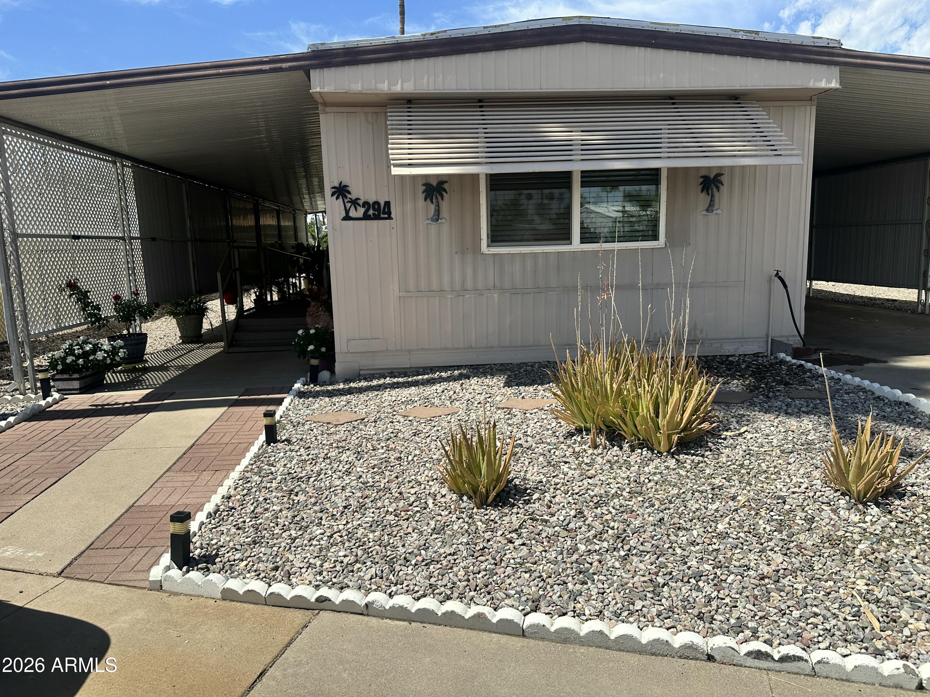Best lot in the community -- truly one of a kind. This home sits with only one neighbor, offering rare privacy with no one behind you and open space on the opposite side. The backyard is a peaceful retreat featuring beautiful artificial turf, mature landscaping, and a large storage shed. Inside, the home has been thoughtfully updated with new laminate flooring, brand-new windows and a recently upgraded kitchen complete with new cabinets and counters. The bathroom has also been remodeled and now includes a walk-in shower. This unique floor plan offers 2 bedrooms and 2 bathrooms, including a primary suite with a walk-in closet, private bathroom, and direct access to the backyard. The home also includes accessibility features such as a handicap ramp and wide hallways. Move-in ready A Must See