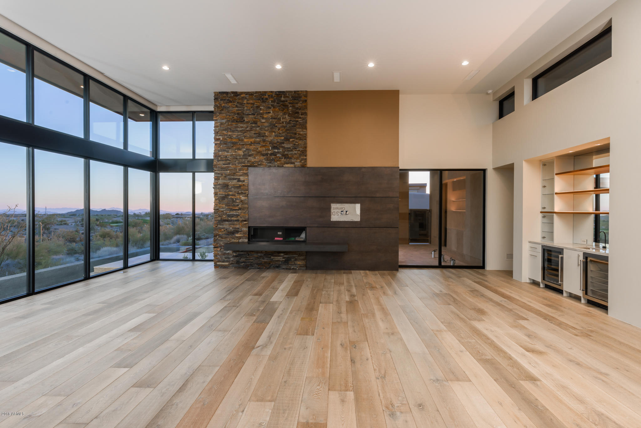 Contemporary and elegant design, built by RJ Gurley Custom Homes, on a site that offers panoramic views of the Sonoran Desert, golf course, majestic mountains and night twinkling lights. Ideal great room and bedroom split floor plan. Ascend the extended driveway to the elevated entrance and you are presented with clean lines, copper fascia, abundant windows and glass, and the warmth of wood and stone accents. Note the cutting-edge simplicity and sophistication throughout the interior:  floor to ceiling glass, clearstory windows, linear fireplaces with stone and porcelain, French Oak floors, slab front cabinets, floating vanities, LED lighting, unique light fixtures, temperature controlled wine room and separate entrance casita with mini kitchen and double vanity bath.  The dividing line between indoors and outdoors magically disappears and results in a wonderful platform for entertaining and a carefree lifestyle.  A heated pool and spa, outdoor cooking, living, and sunning and dining areas complete today's modern lifestyle. The Village of Gambel Quail Preserve is close to the front gate and provides quick access to town, shopping and airport as well as all the amenities Desert Mountain has to offer: 6 golf courses, 6 Clubhouses, restaurants, nature trails, newly remodeled state of the art Sonoran Fitness & Spa and over 15 miles of private hiking trails adjacent to the Tonto National Forest.  A membership is available through the Desert Mountain Club.
