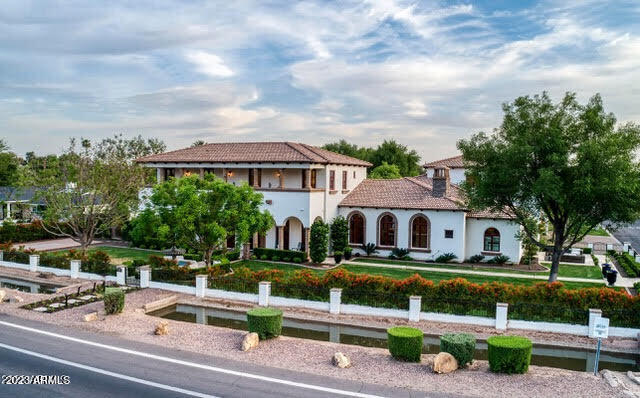 This phenomenal estate has recently gone through an extensive remodel with high style and impeccable taste. It's located on a large lot in Hilker Estates, one of the most sought-after subdivisions in all of Arcadia. If you know Arcadia, you know this cul-de-sac is something special with minimal traffic, home to many young children, and an Easter and Halloween block party like nowhere else in the neighborhood. The sprawling floor plan with high ceilings has room after room of great looking design elements. The chef's kitchen is spectacular with double islands, high end appliances, and more than enough space to prep, serve and entertain. The game room has a custom walk-up wet bar with a convertible pool table/ping pong table, shuffle board,  and additional room for a poker table or arcade for the kids. The home theater has a huge movie screen with THX surround sound, and custom theater seating. The grounds are absolutely exquisite with lush manicured landscape, multiple water features, Cantera stone accents, a gorgeous swimming pool with heater/chiller pump for extended enjoyment throughout both winter and summer, and 12 person hot tub.  Control 4 automation with lighting, audio, HVAC, cameras, intercom, and audio system throughout entire house plus both front and back yards. 4 car garage with 12 foot ceilings tall enough for car lifts, and an amazing sitting area out front for drinking vino with friends while watching the kids ride bikes on a safe cul-de-sac while enjoying a stunning sunset view of Camelback Mountain. This beautiful estate offers an exquisite setting and a very special Mediterranean vibe for the discerning buyer with a penchant for entertaining.