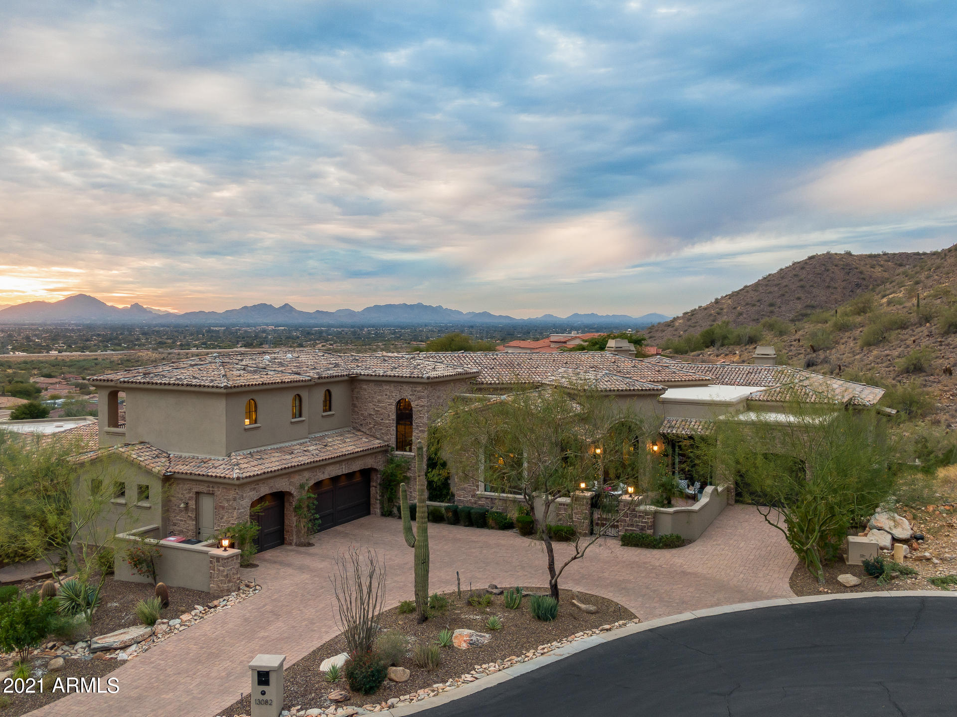 Are you looking for gorgeous mountain and city views from the comfort of your own home? You can check all the boxes with this soft Contemporary-Mediterranean hillside home, located in the popular Ancala Country Club. No expense was spared when designing this estate. From the floor to ceiling, every design detail was carefully thought through, and implemented to ensure the homeowners would want for nothing. Every bedroom is an ensuite, with each one upstairs having its own balcony to enjoy the stunning views, and the downstairs one having a walk-out covered patio to the amazing back yard. The home features a formal living room that opens to the courtyard with mountain views, open family room, formal dining room/breakfast room, bonus room & a stunning eat-in kitchen - all with amazing views from each room! A guest bathroom is not only conveniently located, but is a showcase itself with the custom designed natural stone & iron under-lit vanity. The master bedroom is luxurious, and yet still cozy with its pass-thru fireplace, sitting room and balcony. The walk-in closet features built-ins, along with washer/dryer hookups. The master bathroom has his and hers vanities, an oversized shower and a soaking tub strategically placed to ensure optimal enjoyment of the fireplace and mountain views. Even the laundry room is fully appointed with a large sink and built-in freezer! The outdoor living spaces, from the front courtyard to the backyard and covered patio are the icing on the proverbial cake, with every design feature allowing for mountain and/or city light views. A built-in BBQ & fireplace both add another level of enjoyment to the already well-appointed backyard living space. The uniquely shaped pool and spa allow you to comfortably enjoy starry Arizona nights, gorgeous sunsets and city light views - all from the comfort of your own home. All facts, figures and measurements are approximate, subject to change without notice and not guaranteed by listing agents/brokerage or sellers.