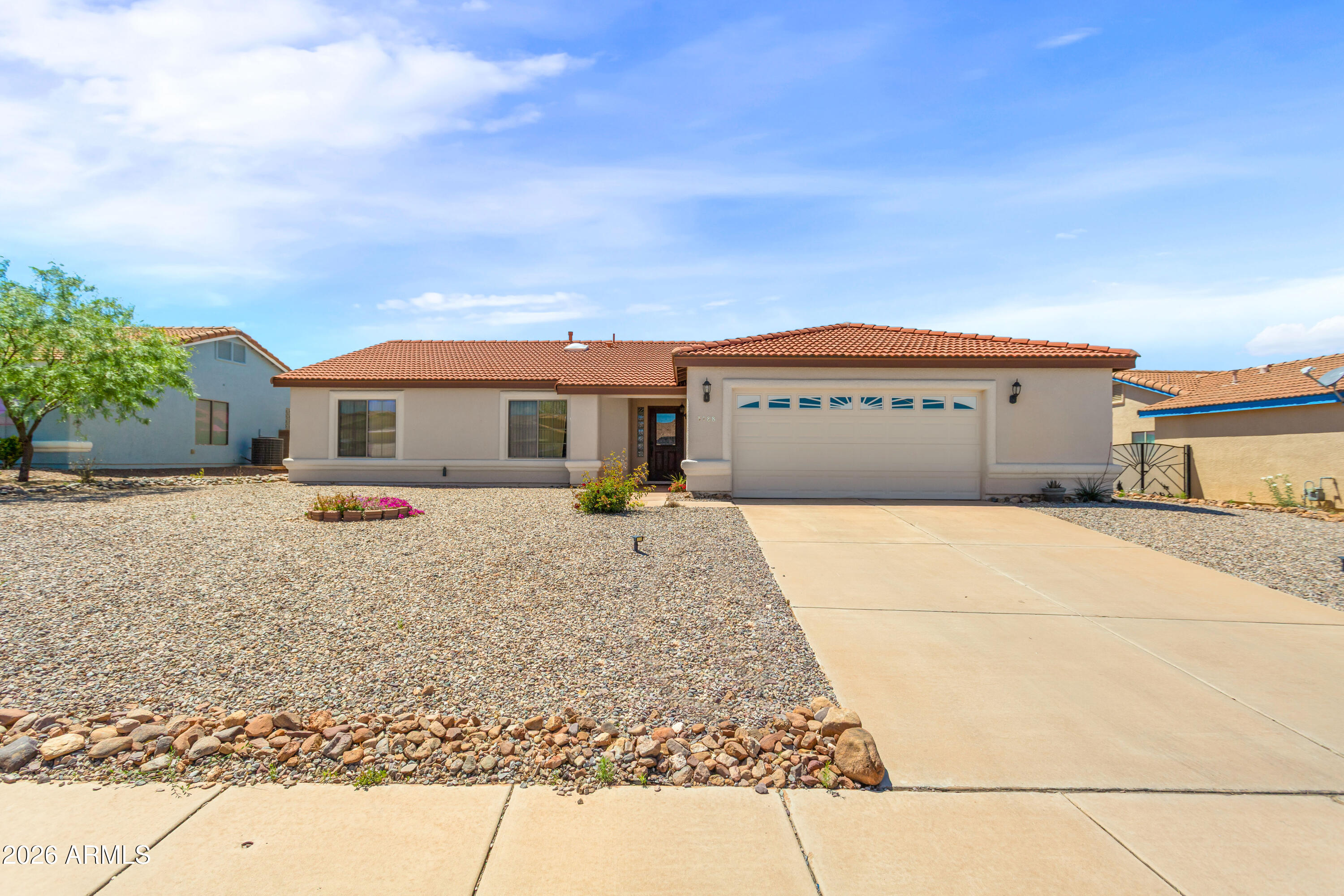 This 4-bedroom, 2-bathroom property boasts a range of high-quality amenities that promise a comfortable and luxurious lifestyle. The house features vaulted ceilings and ceiling fans, creating a spacious and airy atmosphere. The great room is perfect for entertaining, while the enclosed backyard and covered patio offer a private outdoor retreat. The kitchen is equipped with stainless steel refrigerator, gas range, dishwasher, and a convenient breakfast bar. The pantry provides ample storage space. The primary bathroom is equipped with dual sinks for added convenience. The house also includes a laundry room, a 2.5 car garage, and a fireplace that adds a touch of elegance.
