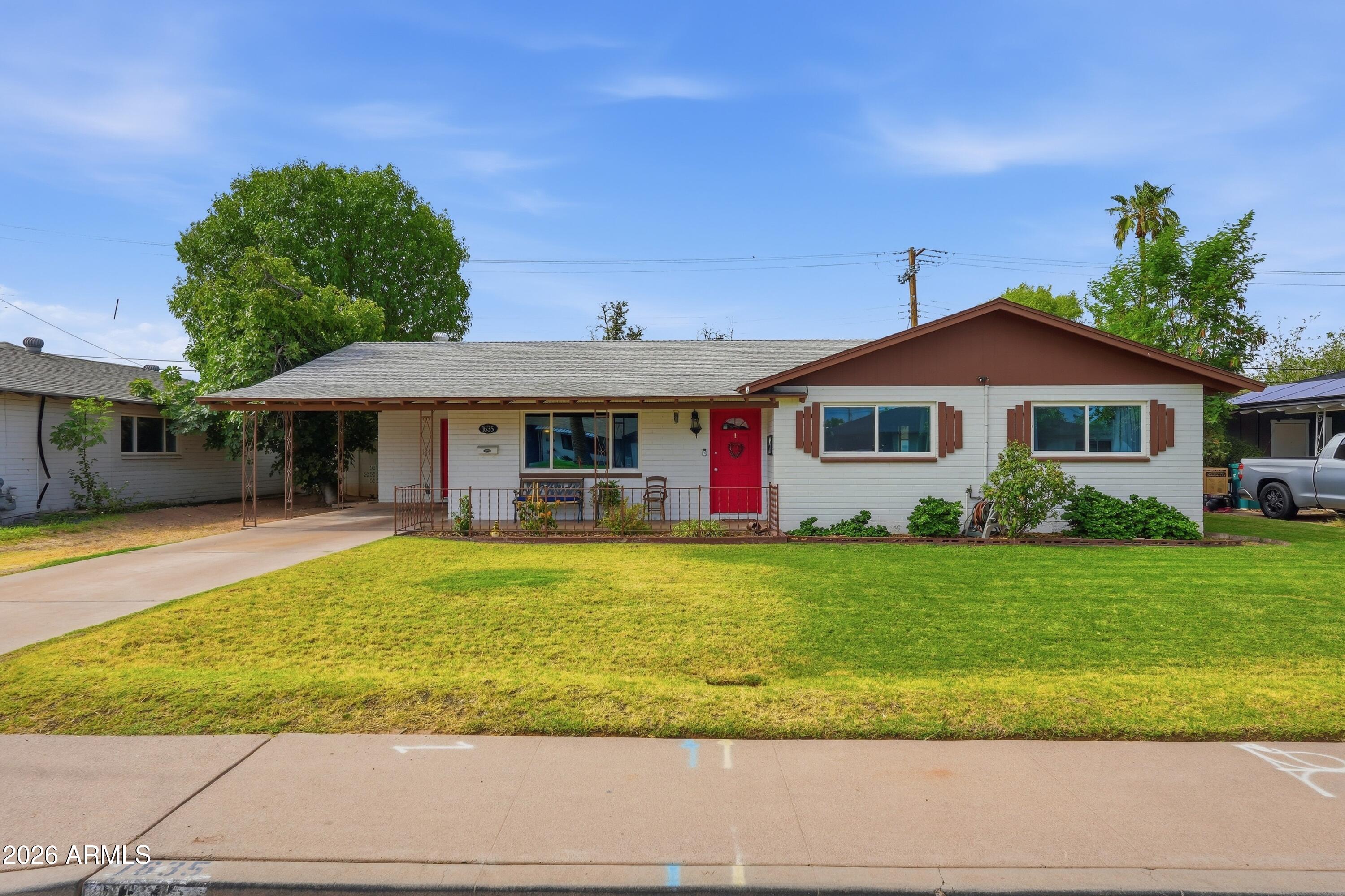 Welcome to this charming single-story home featuring 3 bedrooms and 2 bathrooms, built with durable block construction and energy-efficient features. Tile flooring flows throughout for easy care. Step outside to a long covered patio with misters, an irrigated grassy yard shaded by a mature tree, plus a fenced backyard, storage shed, outdoor utility closet, and carport -- perfect for entertaining or relaxing outdoors. Convenient location close to major highways and public transportation for an easy commute. This inviting property offers comfortable living with practical features inside and out.