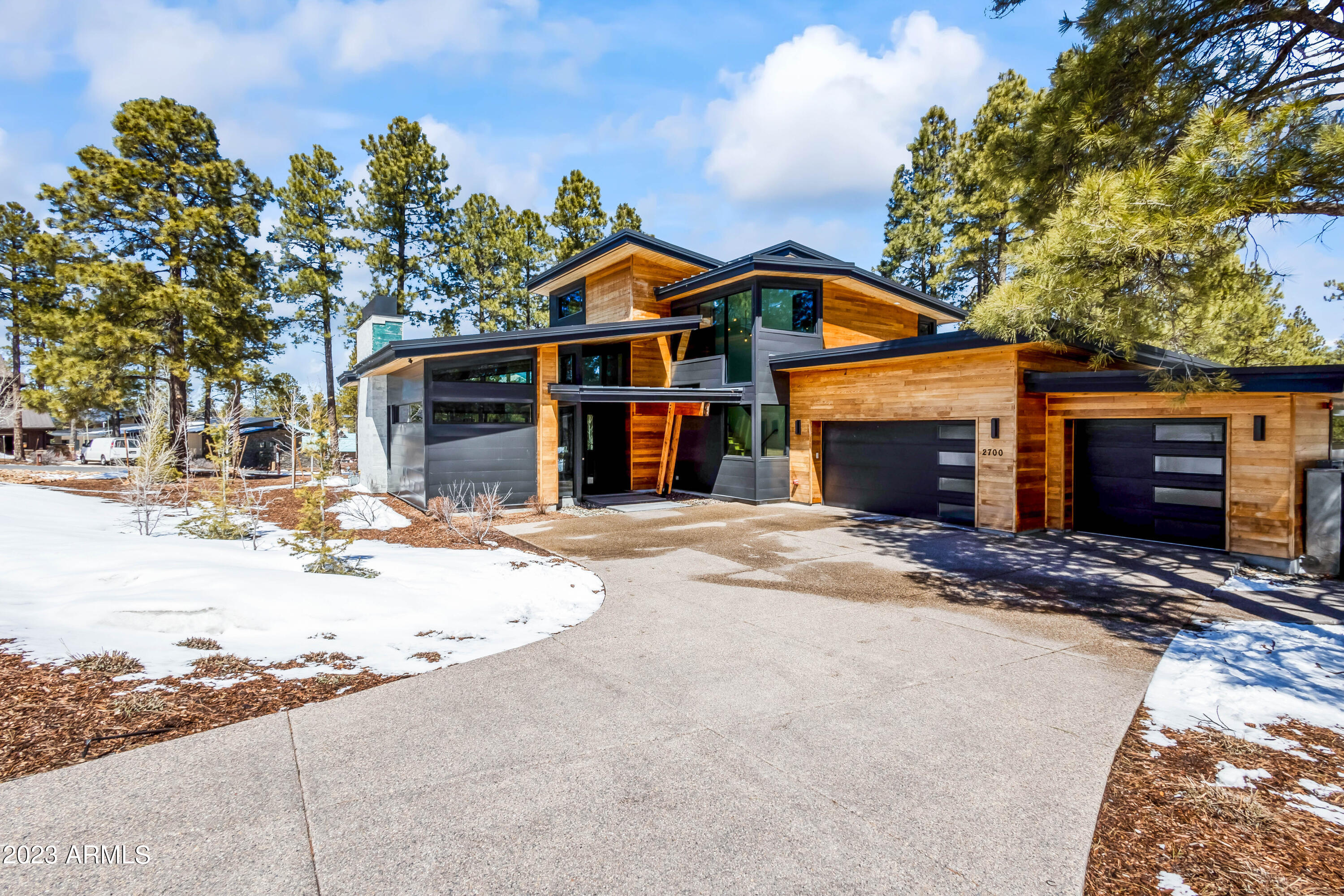 Elevated modern mountain home in the exclusive Pine Canyon golf community. Experience true indoor-outdoor living in this 4 bedroom, 4.5 bath house sitting on a corner lot over a half acre. Designed by Lexi Grace, this 2 story, split floor plan home is situated between the train and hole 18. Main floor includes great room with fireplace, kitchen, dining, and primary. Primary suite features access to outdoor patio, fireplace, walk in closet, dual vanities, and a separate Jacuzzi tub and shower. Upstairs includes guest suites with decks and living room perfect for kids and entertaining. Designed to feature tons of light, modern lines and earthy elements.  Bi-fold doors create the perfect indoor-outdoor space into backyard, beckoning outdoor activities for all seasons. Attached 3-car garage.