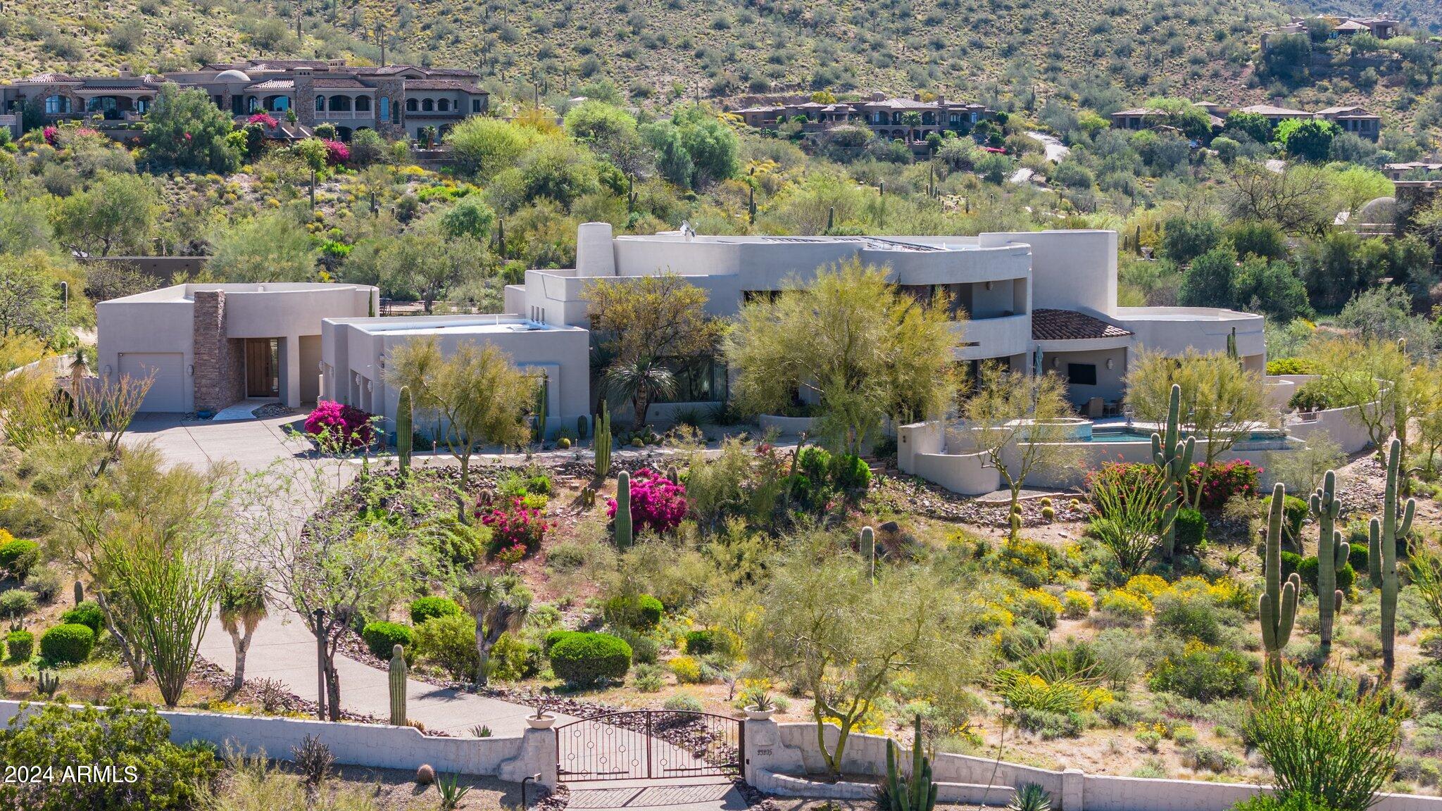 Privately gated Custom home on 2.7 acres with 360 degree views of the McDowell mountains as well as sunset views and city lights.
The primary suite is upstairs with a separate office , sitting area and fireplace, spa like bath, two closets and private balconies to enjoy the views.
Guest house for privacy. Cook's kitchen completes this luxurious home.