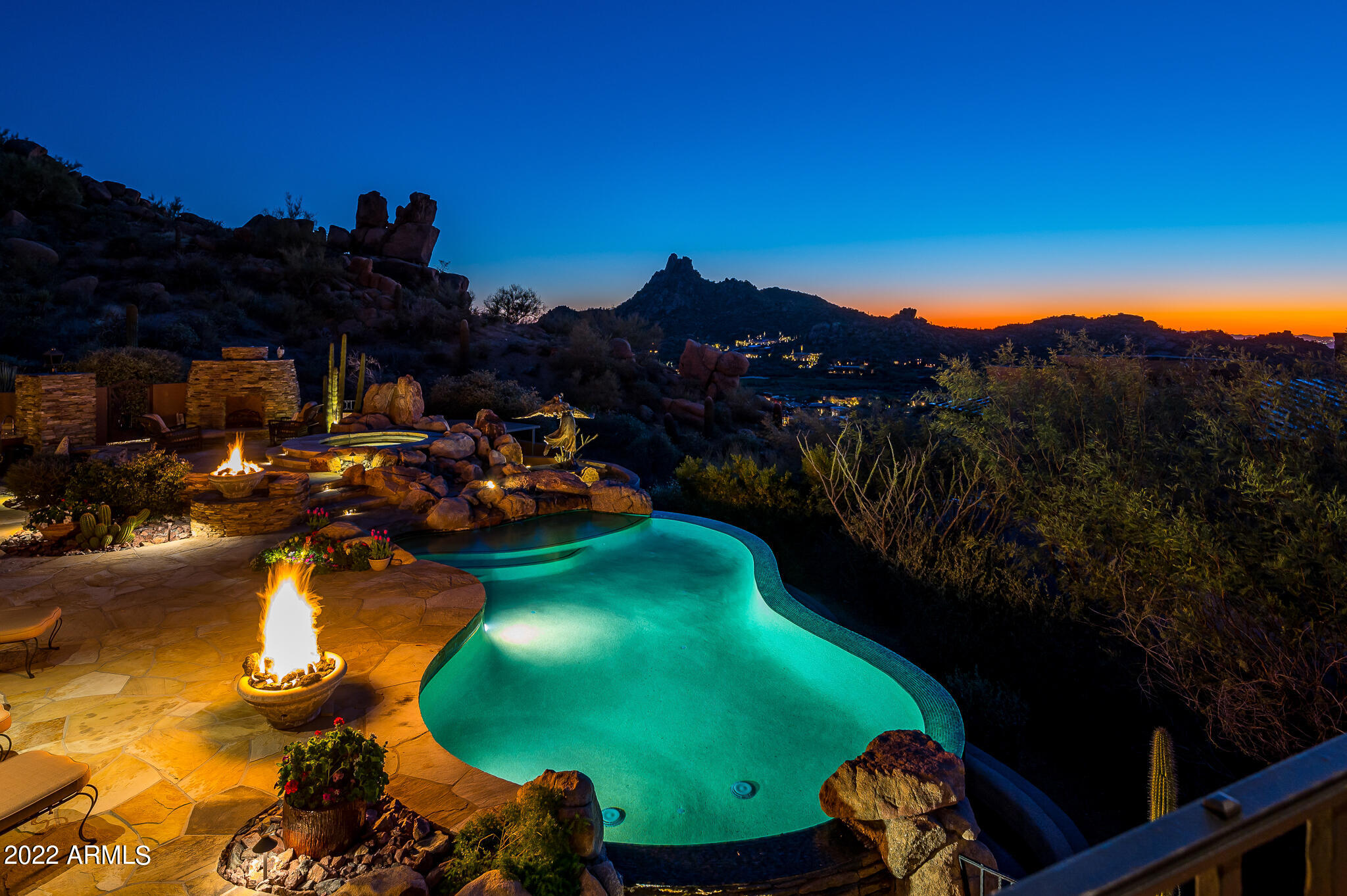 Nestled on a two and half acre homesite amongst the boulders of Pinnacle Canyon, this is truly a one of a kind setting.  Offering some of the most spectacular views in North Scottsdale in virtually every direction, no detail has been overlooked.  An open and inviting floor plan with wonderful ceiling details throughout, expansive patio space with multiple seating areas to enjoy all of the wonderful views from sunrises to sunsets, city lights and mountain views.  This organic southwest home offers 5 suites, study, theater room, exercise room (or 6th bedroom) detached casita with family room and bedroom as well a an oversized 4 car garage with workshop. List price includes all furniture, patio furniture, electronics, art, accessories.  List of updates in the Document section.