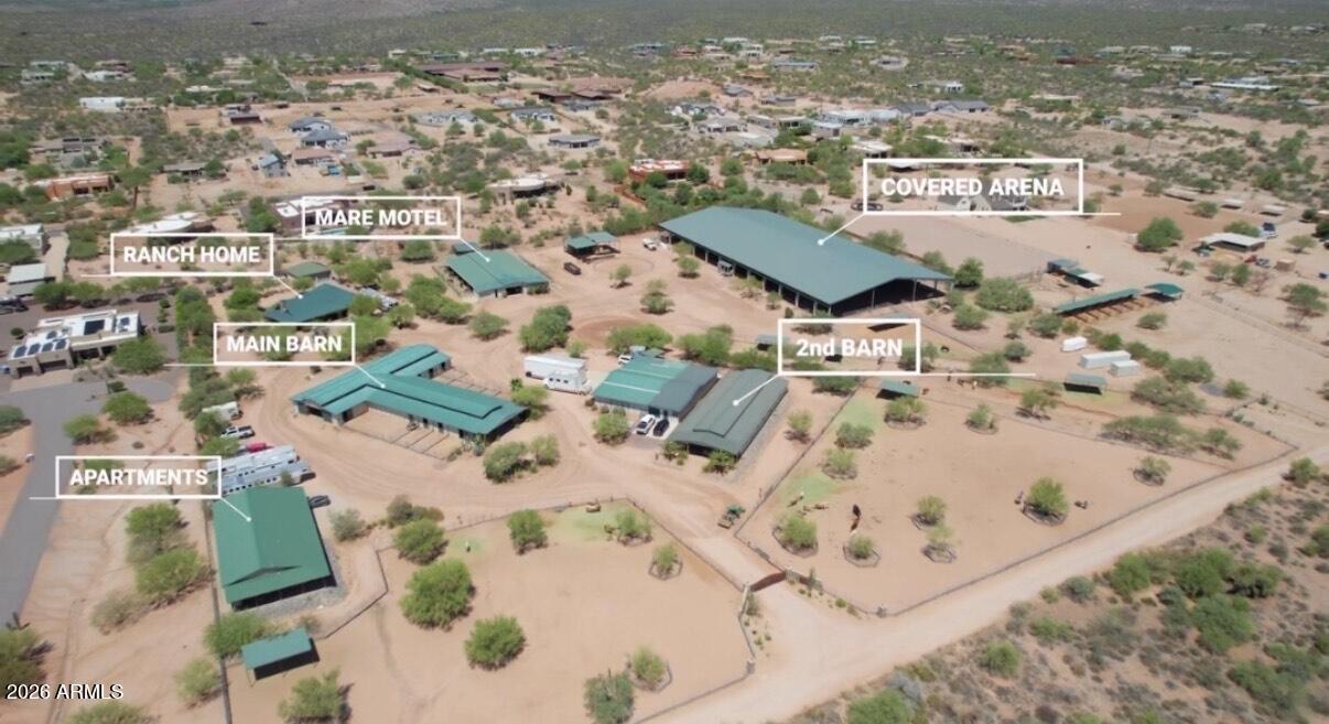 Exceptional turnkey North Scottsdale equestrian estate on 10 pristine acres, designed for the serious horse professional or premier training operation. Located on a quiet road with unbelievable views, this world-class facility is less than 1/4 mile off of a paved road.  This exquisite property features a 145' x 295' covered arena with professional footing, LED lighting, and view deck, complemented by multiple barns.  A secure key-coded gated entry welcomes you to this professionally designed and immaculately landscaped facility.

The property has over 55+ stalls with TWO show barns containing a total of 33 stalls with misting system, fly system, fans and auto waterers. (10 stalls have runs). A total of 3 tack rooms in the show barns along with 6 wash racks and an office. Additionally,  there is up to 24 stalls in the mare motel with two over sized tack/feed rooms, plus 13 additional turnouts. To complete the horse amenities, this property also has a 4-horse hot walker, 60' round pen, a 50x40 covered hay shed and separate shaving bin.

A 3,000+ SF air-conditioned equipment shop has not only an office but is perfect for anything from parking vehicles to storage to a club house for guests and clients. It has a restroom with shower, kitchen, and roll-up doors ; a great space for a multitude of uses.

The custom home includes a 2,212 SF ranch home with primary suite and two secondary bedrooms, stone fireplace, wood beam ceilings, granite countertops, covered patios, and a detached two-car garage. Additional accommodations feature three well-appointed apartments (±850-900 SF each) two 2BR/1BA and one 1BR/1BA PLUS an additional ±900 SF 2BR/1BA apartment--ideal for staff housing, guests, or income potential. Additionally there at 4 full RV hookups by the apartments and one at the shop.

Served by a private well (±10 GPM) with 6,660-gallon storage tank and ideally located just minutes from WestWorld, Scottsdale Airport, and premier desert trail riding. A rare opportunity to own a fully built, income-capable Scottsdale equine facility ready for immediate operation.