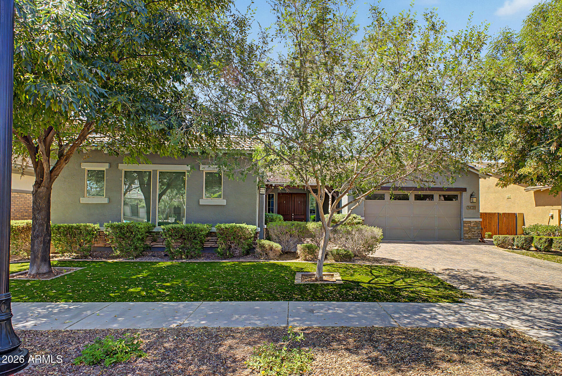 Welcome to this move-in ready single-story home in the highly sought-after Morrison Ranch community. This beautifully maintained 4-bedroom, 3-bathroom split floor plan features a spacious open-concept design perfect for modern living, complemented by a spacious 3-car garage for ample parking and storage. The chef's kitchen boasts an oversized island, gas cooktop, and stainless steel appliances, seamlessly connecting to the main living and dining areas -- ideal for entertaining family and friends. The private primary suite offers dual vanities, a large walk-in closet, and a peaceful retreat for relaxation. Step outside to enjoy Arizona's beautiful weather on the covered patio with upgraded pavers, perfect for outdoor gatherings and quiet evenings. Nestled in a friendly, well-established neighborhood, this home is conveniently located near parks, greenbelts, shopping centers, dining options, and top-rated schools. Whether you're a growing family or looking to downsize, this Morrison Ranch gem combines comfort, style, and convenience in one exceptional package.