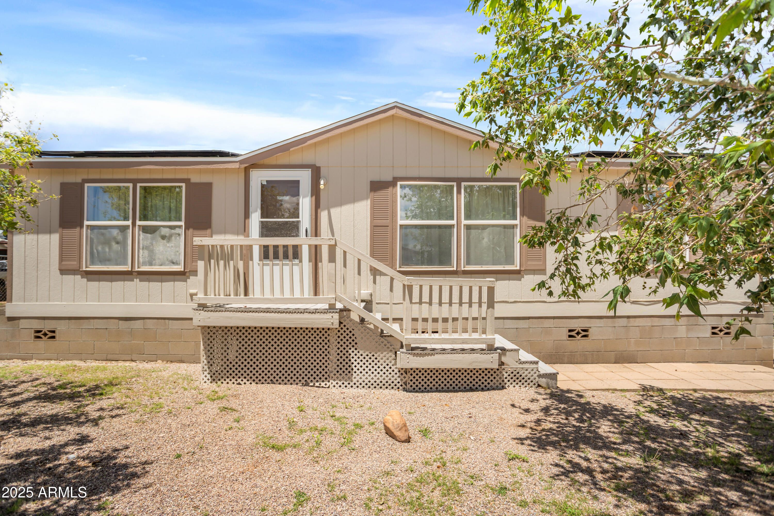 This charming home offers comfortable living with desirable upgrades.This 3-bedroom, 2-bathroom residence boasts an energy-efficient feature with owned solar panels. The exterior features a back yard covered deck with ramp access. It also offers a low-maintenance, fully fenced yard with  gravel landscaping in both the front and back, minimizing yard work while maximizing curb appeal.