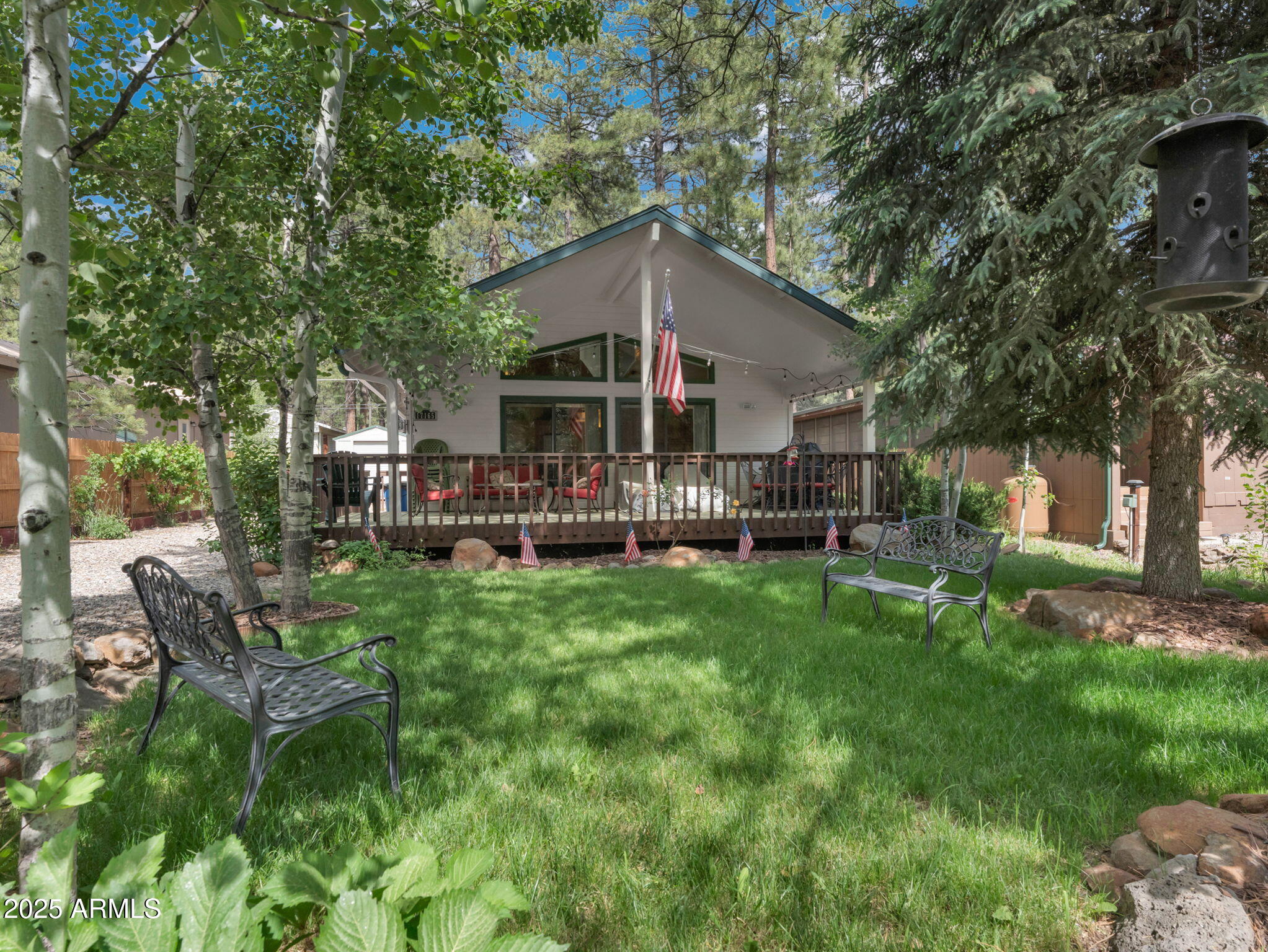 BRAND NEW ROOF. Site-built single-family home in Munds Park, fully furnished and priced under 500K! 

Tucked beneath the towering pines of Munds Park, this cozy mountain retreat offers a perfect blend of rustic charm and modern comfort. Vaulted ceilings and an open-concept living area create a warm, inviting atmosphere, centered around a wood-burning fireplace, an ideal place to gather after a day of exploring the outdoors.
An expansive front deck invites you to unwind among the trees, whether you're sipping your morning coffee or hosting friends on a cool summer evening. The home's layout is well-suited for both relaxed weekend getaways and extended stays, making it a great option for full-time living or a high-demand vacation rental. Munds Park is a beloved mountain community just 20 minutes south of Flagstaff, known for its access to the Coconino National Forest, Pinewood Country Club, and an extensive network of trails for hiking, biking, and ATV adventures. With cooler summer temperatures and a close-knit feel, it's the kind of place where neighbors wave from their decks and life slows down just enough to enjoy it. Whether you're seeking a peaceful escape or a base for outdoor fun, this home puts it all within reach.

Owners are willing to sell with most furnishings.
Trustee is a licensed real estate agent in AZ