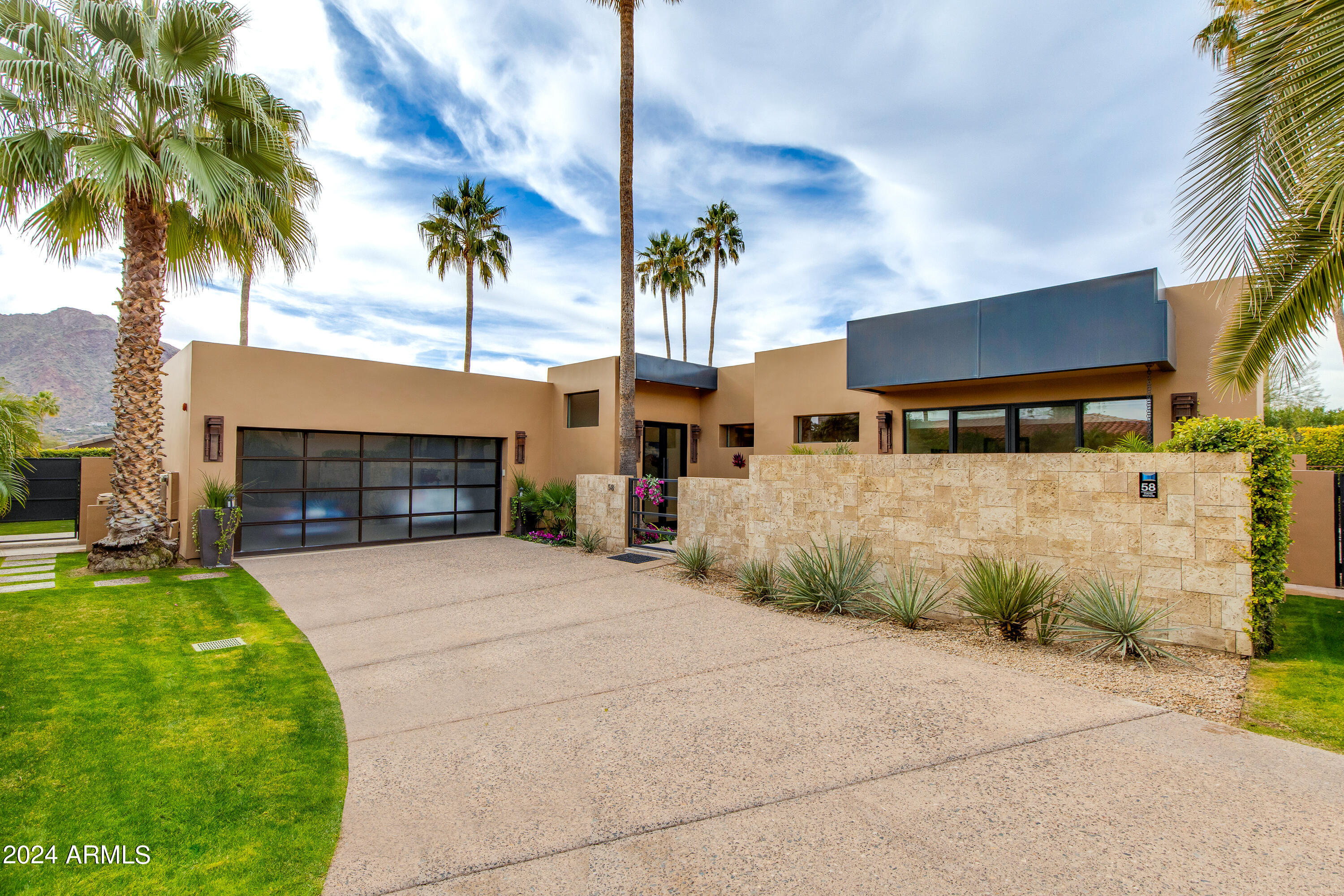 Welcome to Paradise Valley's best kept secret, situated within the guard gated community of Colonia Miramonte and nestled between the historic Camelback Inn and El Charro. This magazine worthy home was featured in Phoenix Home and Garden and is also the former home of Hollywood actor Charles Boyer, who chose the home for its privacy and intimate Camelback Mountain views. This special home has been adorned with antiques from all over the world and exudes a refined elegance. Completely reimagined from top to bottom and featuring soaring 12' ceilings throughout; along with custom floor-to-ceiling glass doors which flood the home with natural light and open to the backyard offering a perfect blend of indoor/outdoor living. A true chef's kitchen overlooks the great room and comes equipped with a Thermador gas range, Miele cappuccino machine, SubZero glass wine cooler and refrigerator/freezer drawers. The massive fireplace sits as the living room's centerpiece and provides an inviting setting to entertain around.  The spacious primary suite has its own private courtyard complete with fire feature and a fountain. While the spa like primary bath boasts a soaking tub, glass shower, dual vanities and a custom walk in closet. Relax and bask in the views of both Mummy and Camelback Mountains from one of the private patios with the tranquil sounds of the fountains in the background as you enjoy a glass of wine and soak in the sunset. Order room service or walk to the Camelback Inn when you're ready to enjoy a world class dinner, here it is all at your beckon call.