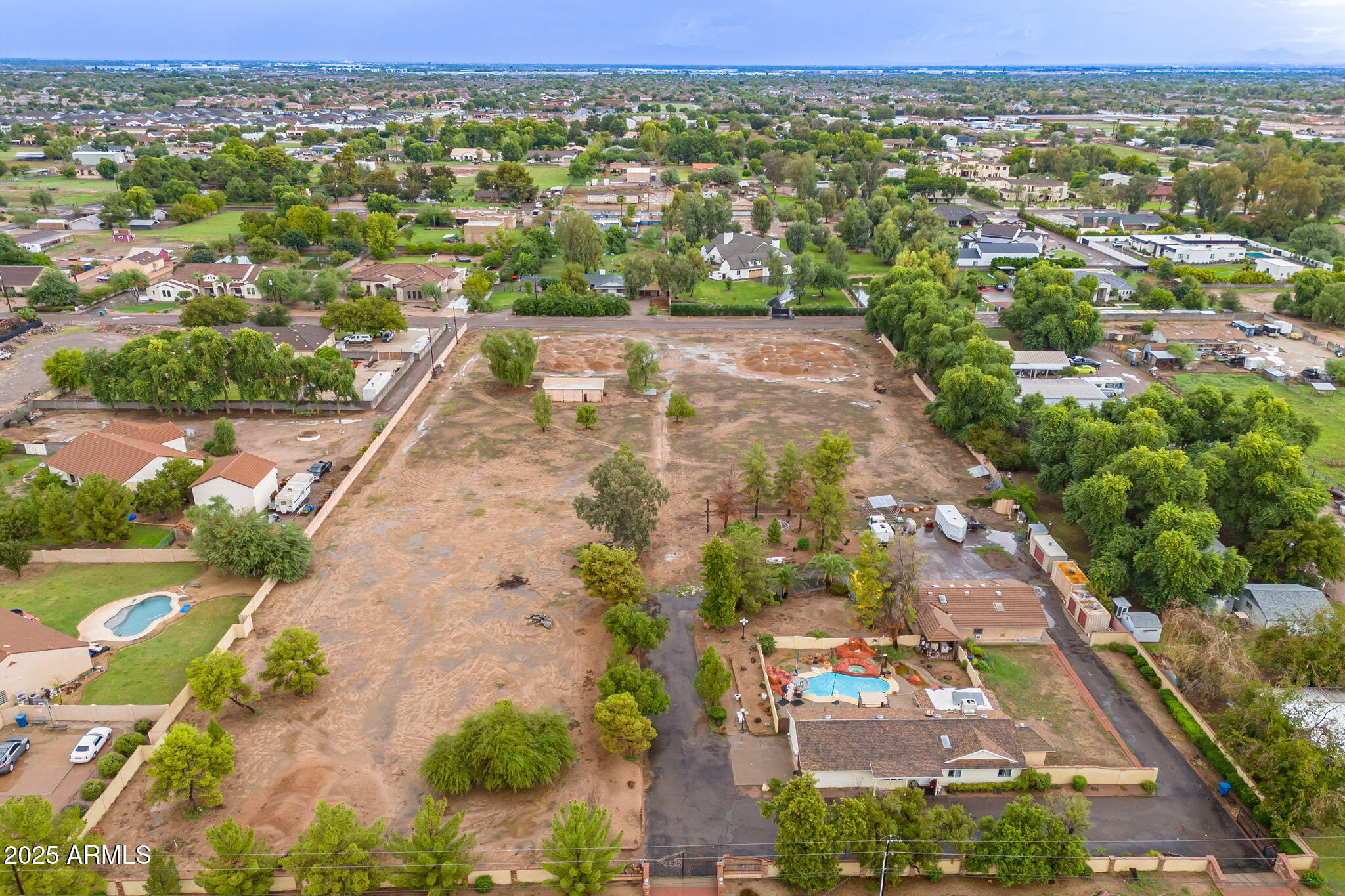 Experience the rare opportunity to own one to nearly five acres of pristine land nestled within a quiet county island in South Chandler, where country living meets city convenience. Three surveyed parcels, each just over one acre and offered at $850K each, the lot with the house present is offered at $995K, This unique opportunity invites you to build your dream estate, equestrian property, or luxury retreat. Or, for those seeking something more grand, purchase all four parcels together (just under five acres total) to create your own private compound! Each parcel enjoys road access via quiet side streets and boasts a north-south orientation for ideal sun exposure. The lots are flat, build-ready, and benefit from SRP electric, SW Gas, and city water.