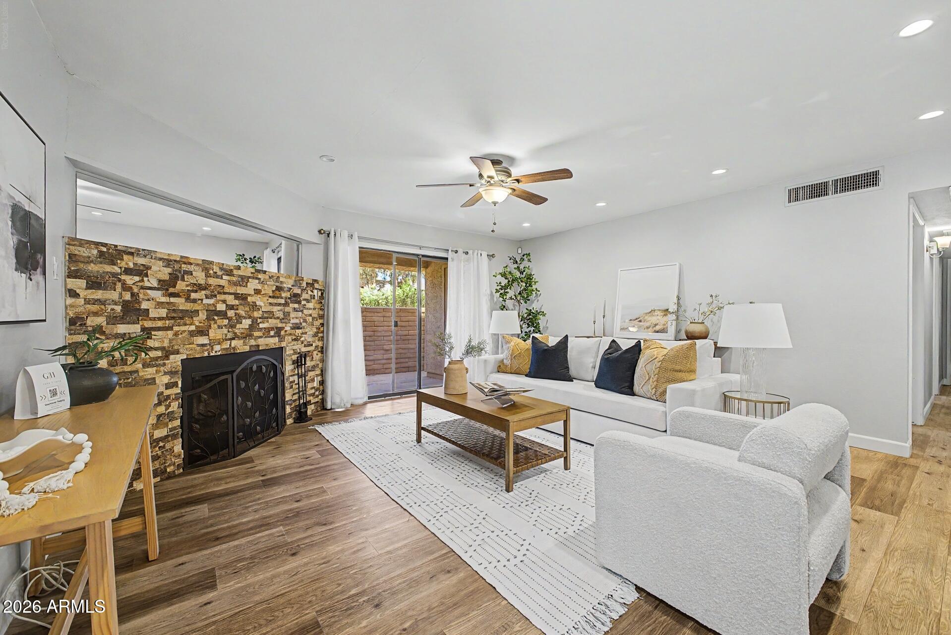 Rare, first level, 1500sf, three bedroom, two bathroom condo in the heart of Scottsdale. Luxury vinyl flooring throughout home including the bedrooms. Bright & open kitchen with white cabinets, quartz countertops & stainless steel appliances including fridge. Primary bedroom with walk in closet, & huge spa inspired walk in shower. HVAC 2024. Two private balconies. Wood burning fireplace, recessed lighting, and inside washer & dryer. A stunning heated community pool and grilling area. The green belt is seconds away, offering miles to bike, run, and play. Shops & dining are around every corner. Surrounded by dog parks, sand volleyball courts, basketball courts, pickleball courts, & picnic areas. Short Term Rental approved! Find your newest Scottsdale investment. 1 covered parking spot