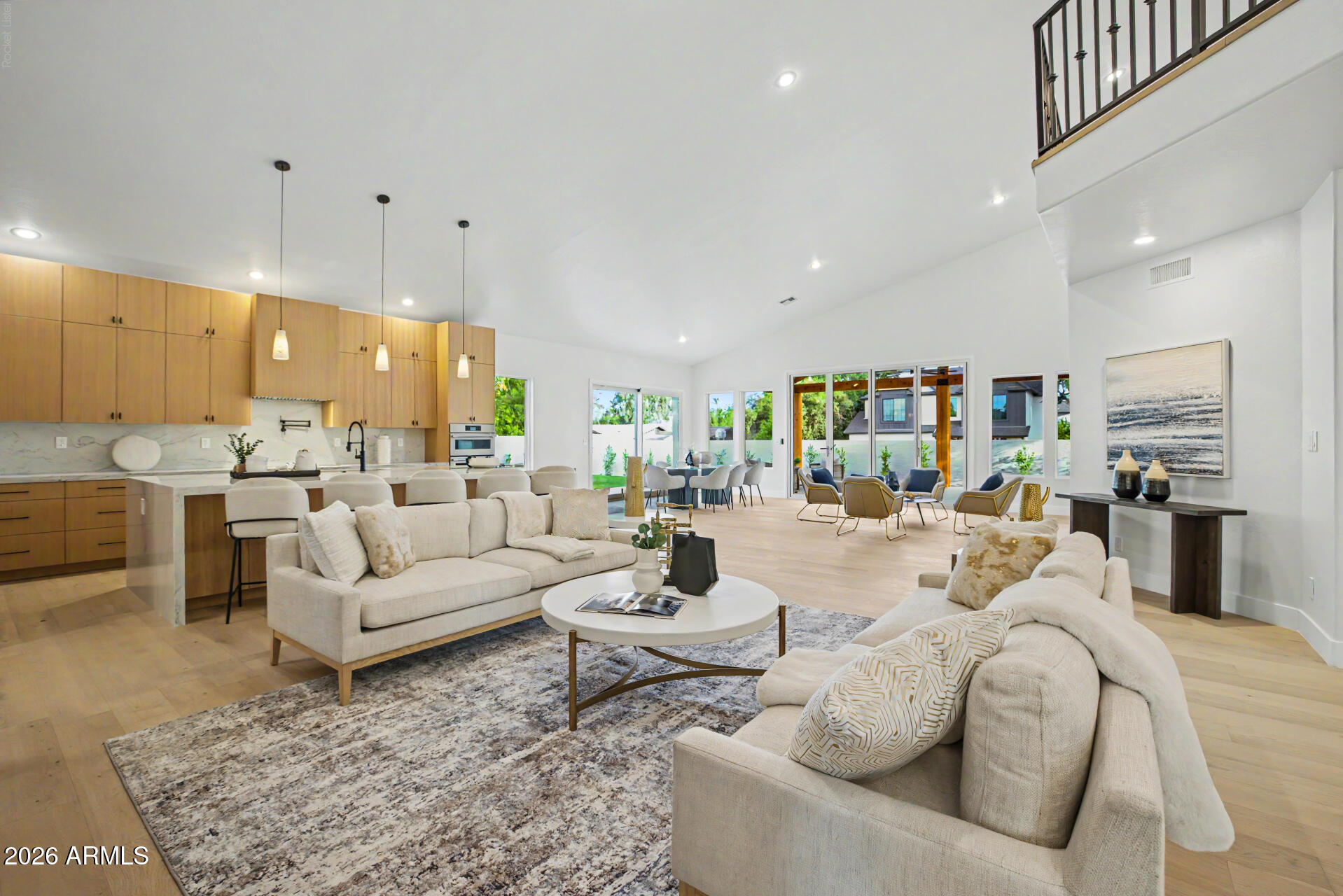 Welcome to 1321 W. Gardenia Avenue, an exceptional North Central Phoenix residence where timeless design meets modern luxury. Recently remodeled from top to bottom, this stunning home offers 5 bedrooms, 5.5 bathrooms, a dedicated office, an expansive upstairs loft, and sits on a 16,000+ square-foot lot designed for seamless indoor-outdoor living. Soaring ceilings, abundant natural light, and designer finishes create an inviting atmosphere throughout.

At the heart of the home, the gourmet kitchen features marble countertops with a full-height marble backsplash, premium Viking and Bosch appliances, a spacious walk-in pantry, new blonde hardwood flooring, and overlooks the open-concept living and dining spaces. A dramatic wrought-iron staircase serves as a striking architectural centerpiec The spacious primary suite offers a private sitting area, spa-inspired bath with a soaking tub, dual-head walk-in shower, oversized closet, and the convenience of its own laundry. Every secondary bedroom includes a private en-suite bath with an oversized walk-in shower, providing comfort and privacy for family and guests. Upstairs, the versatile loft creates the perfect space for a media room, homework station, game room, or teen retreat.

Designed for Arizona living, two oversized multi-slide glass doors open to a spectacular 600+ square-foot covered patio accented by exposed beam detailing. White limestone hardscaping, lush mature landscaping, custom lighting, and a full irrigation system create a resort-style backyard built for year-round entertaining.

Additional highlights include updated HVAC systems, a three-car garage with epoxy floors, and dual laundry areas for everyday convenience.

Residents enjoy a neighborhood green space with a large open field and a gated sports court featuring basketball, pickleball, and tennis. This move-in-ready home is a rare opportunity to own a beautifully renovated property in one of North Central Phoenix's most sought-after neighborhoods.