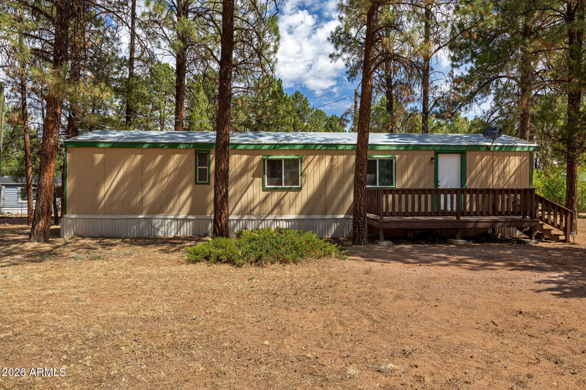 Charming, move-in-ready manufactured home tucked into a quiet Overgaard neighborhood and surrounded by towering ponderosa pines. Thoughtfully updated throughout, this home features new flooring, fresh cabinetry, updated countertops, stainless steel appliances, and new dual-pane windows for year-round comfort and efficiency. Step outside to the elevated front deck, the perfect spot for morning coffee or entertaining under the trees. A storage shed on the property provides convenient space for outdoor gear and seasonal items. With the surrounding national forest just moments away, you'll enjoy easy access to hiking, exploring, and all the natural beauty of Arizona's high country. Whether you're looking for a full-time residence or the ideal mountain vacation getaway, this property delivers . Seller is a licensed real estate agent in Arizona.