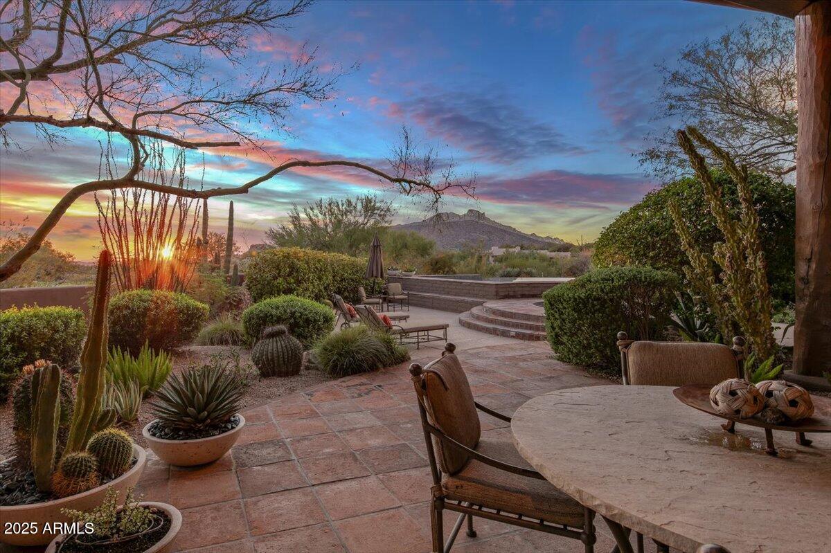 This spectacular custom home by Lee Hutchison is a true desert retreat, ideally situated on a premium golf course lot with breathtaking views of Black Mountain, The boulders, and unforgettable sunsets. Designed for ultimate comfort and upscale living, the home boasts an elevator-accessible upstairs primary suite with a private deck, double vanities and water closets, dual walk-in closets, and a luxurious snail shower. Enjoy seamless indoor-outdoor living with expansive entertaining spaces, a negative edge pool, hot tub, outdoor fireplace, built-in BBQ, and a cozy fire pit - all beautifully lit with custom outdoor lighting. The chef's kitchen features a Sub-Zero refrigerator/freezer, 6-burner Dacor gas cooktop, double Dacor ovens, warming drawer, wood countertop island with prep sink, spacious walk-in pantry, and a built-in TV. A two-way fireplace connects the elegant dining room with the inviting kitchen sitting area. Rich architectural details include box beam ceilings with tongue-and-groove accents, electric sun shades, and multiple fireplaces including one in the great room. The home also includes a spacious laundry room with built-in cabinets and desk perfect for hobbies or an art studio. The oversized 2-car garage is complemented by an additional golf cart garage. This is a one-of-a-kind property designed for both luxury and lifestyle. Don't miss your chance to own this resort-style haven!