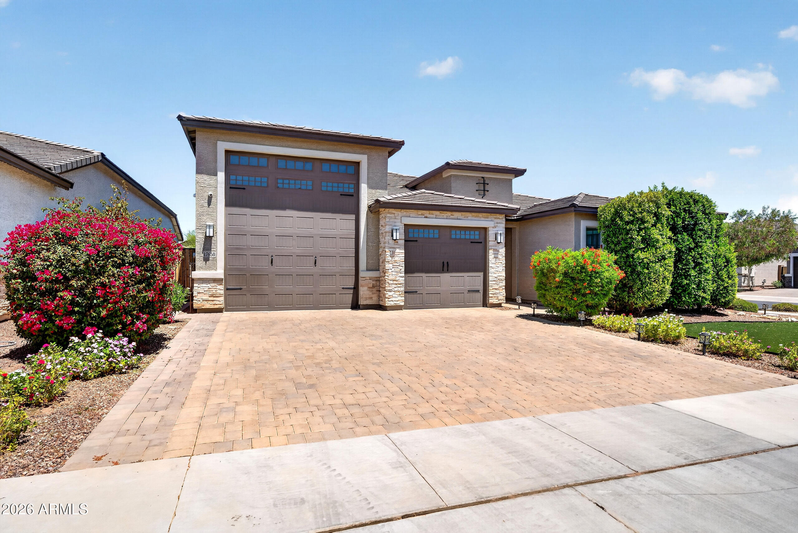 The Ultimate Setup for Off-Roaders, Boaters & RV Enthusiasts. This 3-bed, 2.5-bath home with a flex room and a massive RV garage is tailor-made for those who live for the outdoors. With Lake Pleasant just 30 minutes away and immediate access to off-road trails, this home offers not just luxury but freedom. Skip the monthly storage fees. Your oversized RV bay includes an epoxy-coated floor, RV clean-out, dual mini-split A/C units, and custom storage, ideal for your boat, UTV, or Class A rig. There's plenty of space for your gear, tools, and toys, all right at home. Inside, the upgrades continue with custom barn doors, a built-in shoe rack, motorized blinds, and designer hexagon LED lighting in the garage. The kitchen features a Cafe Series GE oven and range along with a Samsung Smart Hub fridge, all part of a black matte stainless steel, fingerprint-resistant suite. Premium window treatments, upgraded flooring, and a 7-camera NVR security system complete the polished interior.  A dedicated flex space offers the perfect setup for a home office, gym, or playroom ready to adapt to your lifestyle.  Step outside to your private backyard retreat featuring $30,000 in professional landscaping, a custom pergola, commercial-grade bistro lighting, and a 4-person spa, perfect for relaxing after a day on the water or trails.  Additional upgrades include a whole-home soft water system, additional garage laundry setup with washer hookup, and smart-home conveniences throughout.  Whether you're seeking adventure, space, or simply a better way to live, this home delivers it all without compromise.