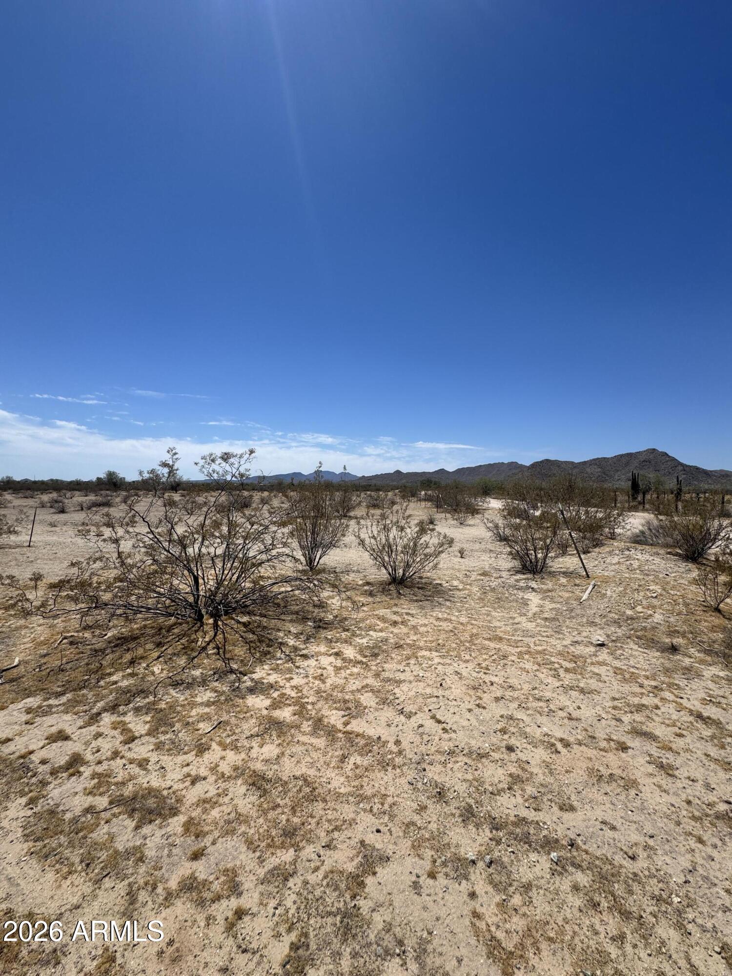 Build your dream home on this 1.25-acre parcel in rural Arizona! Featuring a shared well, power at the lot line, and stunning mountain views, this property is ready for your custom build. With approximately 193' x 255' dimensions, there's plenty of room for horses, RVs, toys, workshops, and all your outdoor hobbies. Enjoy peaceful country living with wide-open spaces while remaining conveniently located just 15 miles from the City of Maricopa. Adjacent parcels are also available for purchase, offering the opportunity to expand your acreage and create your ideal rural retreat. Don't miss this opportunity with endless possibilities.