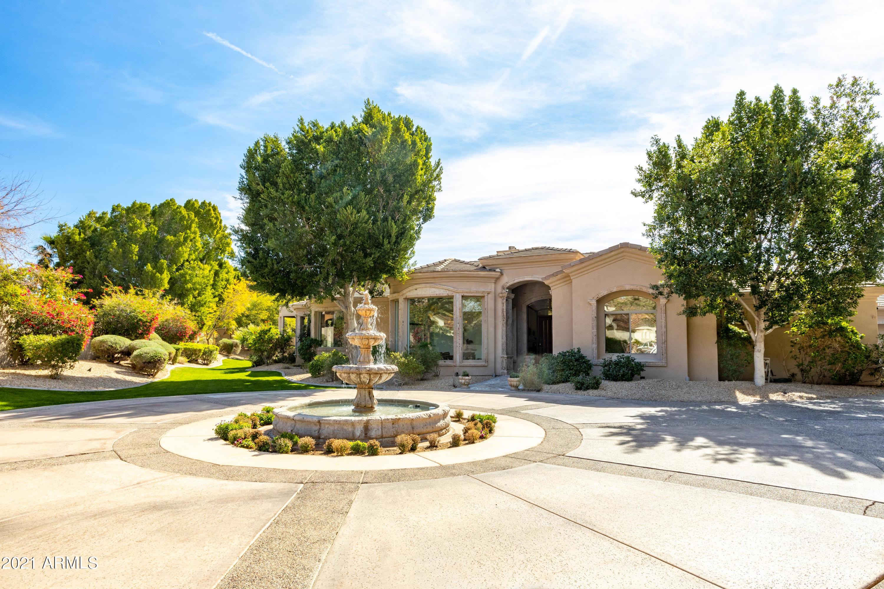 Gorgeous gated estate in a phenomenal cul-de-sac along the south base of Camelback Mountain with breathtaking views and an abundance of elegant charm. This exquisite estate boasts 5 en-suite bedrooms, 5.5 bath, 4 car garage and a bonus room great for a workout or craft room. Luxurious master suite with mountain views, fireplace, dual vanities, jet tub and huge walk-in clotting closet. Gourmet kitchen that opens to family room with granite counter tops, large eat-in kitchen island, double ovens and double dishwashers.  Sprawling ground with magnificent pool and spa, water fountains, putting green, outdoor kitchen and plenty of covered patio space. This home is simply splendid!