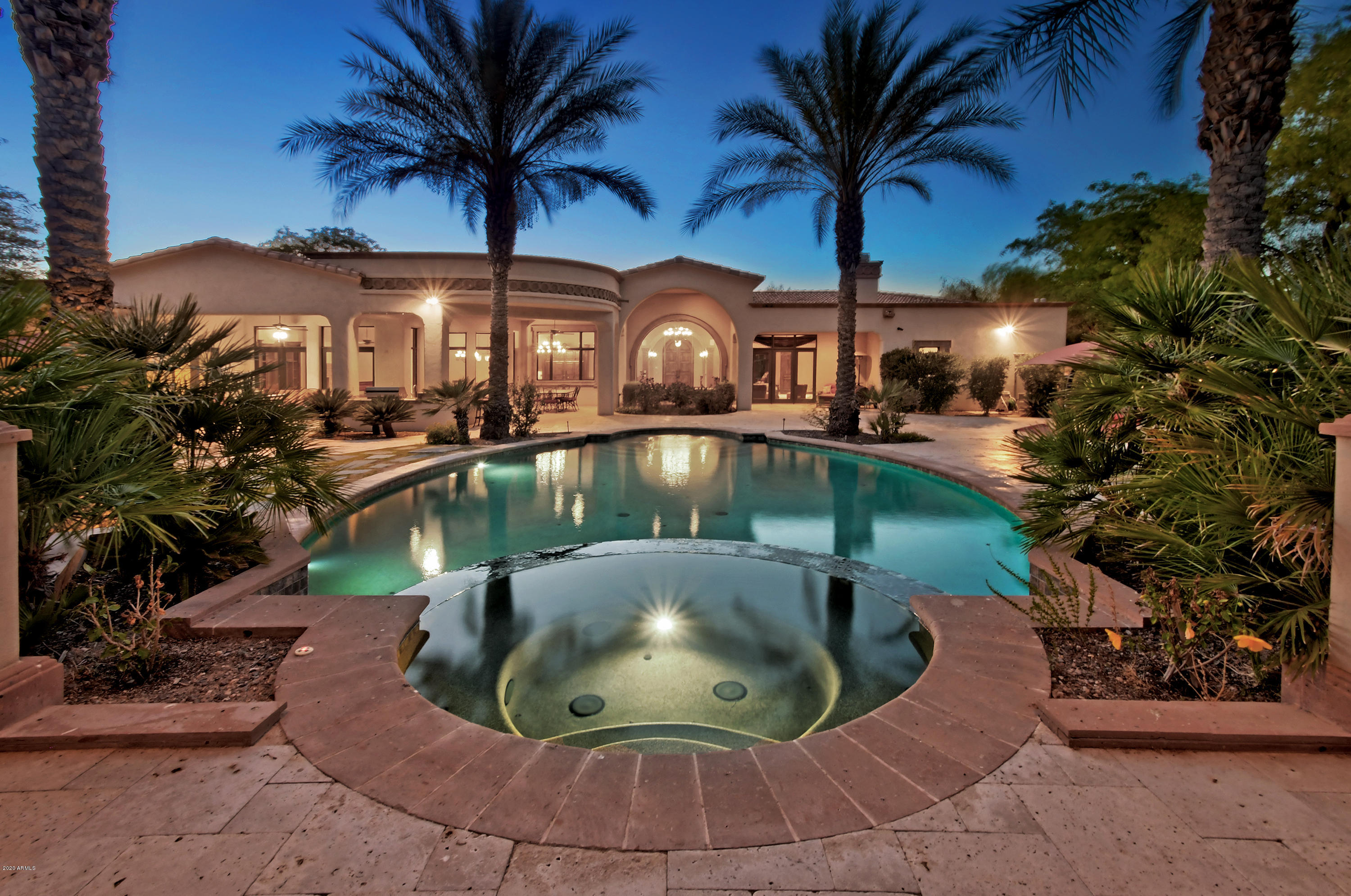 This gorgeous Paradise Valley home offers envious views of Mummy Mountain. Built by American Traditions, the home boasts 4 bedroom suites, guest quarters with kitchenette, split floor plan with children wing, wine room, butler's pantry, dual offices, all spanning nearly to 8,000 SF all on one level! Timeless, exquisite, hand-crafted details adorn this property from ceiling treatments to custom cabinetry. The backyard is an oasis with travertine pavers, side garage access, beautiful pool, elevated spa with fire pit and custom seating perfect for entertaining. Don't miss the master courtyard fireplace and fountain perfect for a relaxing evenings. SEE Motion Video under Photo Tab. Tenant rights, plan ahead to preview!! see MOTION VIDEO