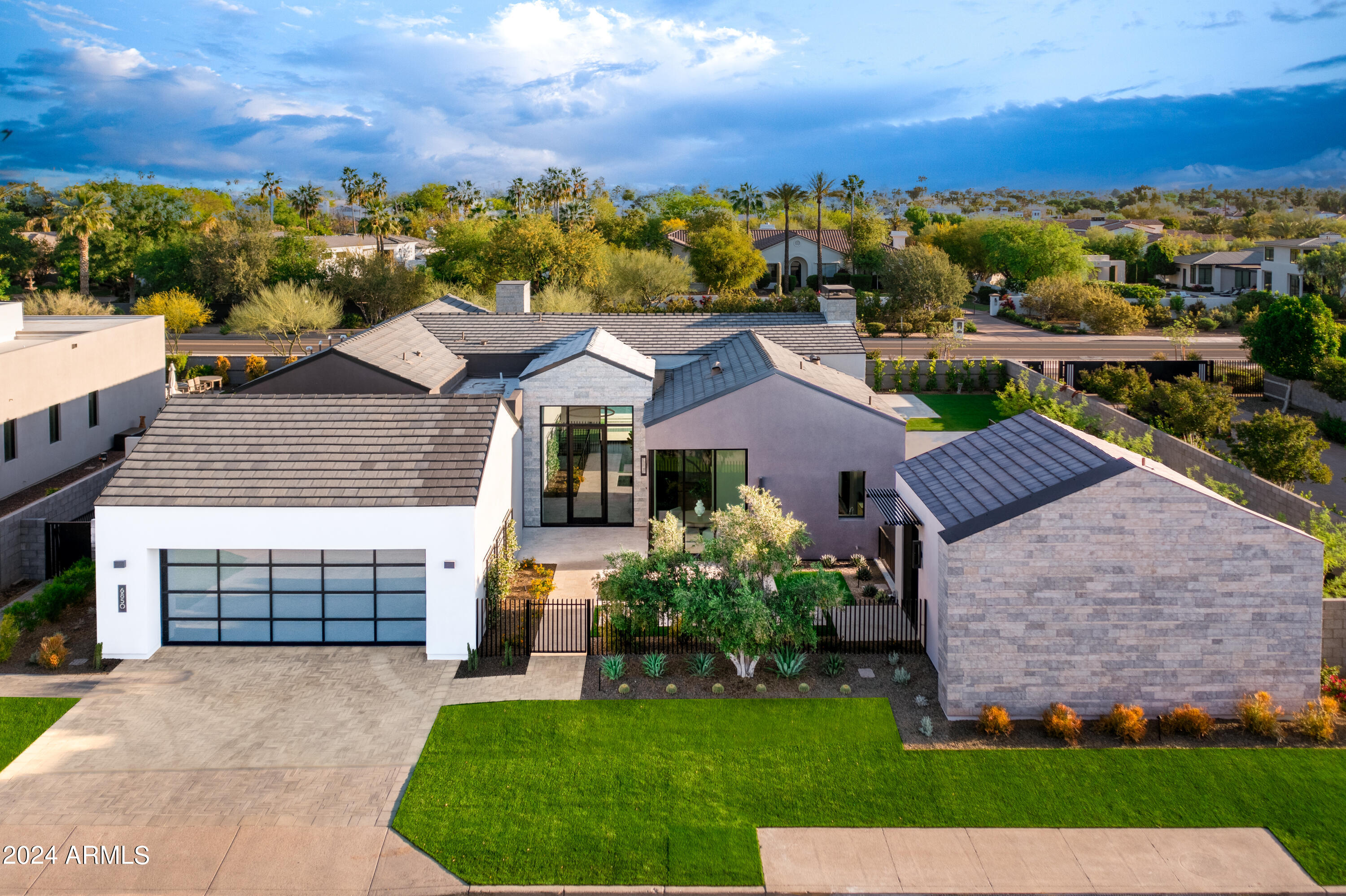 This is a phenomenal opportunity in the highly sought after Azure community in the heart of Paradise Valley. The oversized corner homesite is absolutely spectacular with fresh contemporary design and state of the art custom finishes. The gourmet kitchen is outfitted with Gaggenau appliances, inductions and gas cooktops, wine tower, steam oven and warming drawers. The living spaces are super elegant, yet ultra comfortable featuring a custom paneled media center, full wet bar, wine room, home office, private workout area and gorgeous guest casita. The lavish design elements include old world stone, Ann Sax tile accents, exquisite wallpaper, sleek custom cabinetry, impressive lighting, a beautiful pool and water features in both the front and back. The modern design is innovative, the entertaining options are endless, and the setting and views are outstanding making this a very special residence!