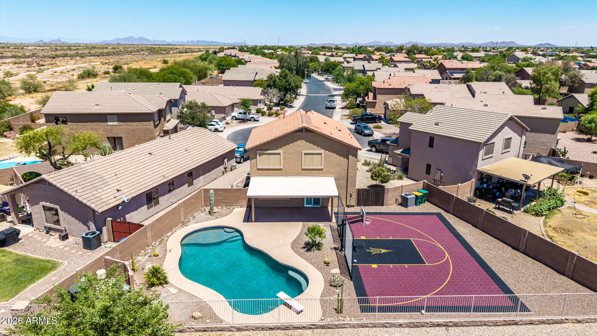WOW!! Your dream backyard is here!   HUGE cul-de-sac lot that backs to a wash, providing spectacular sunset views and privacy.  There is a 24,000-gallon heated diving pool, and a custom sport court that will make you the envy of the neighborhood.  The interior is just as impressive-- Vinyl plank flooring throughout the entire house (NO CARPET!), remodeled kitchen with white shaker cabinets, Taj Mahal quartz counters, and stainless appliances, new paint, upgraded bathrooms including a custom tiled shower, and much more.  3 bedrooms plus a loft that could become a 4th bedroom.  The HVAC system was replaced in 2025, and the water heater in 2024.  This beautiful move-in ready home in the golf course community of Rancho El Dorado is one you don't want to miss!