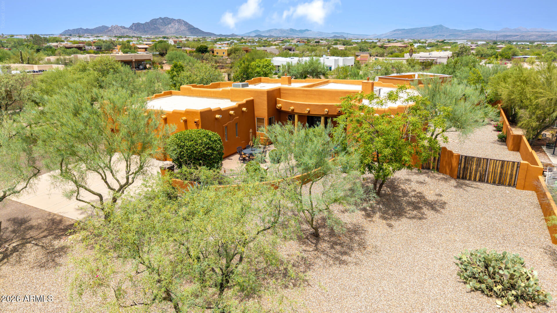 Experience timeless Santa Fe elegance in this exceptional North Scottsdale retreat. Thoughtfully designed with an open split floor plan, this beautifully crafted home showcases rich hardwood flooring, soaring ceilings, stone fireplaces, and abundant natural light. The gourmet kitchen is appointed with custom cabinetry, granite countertops, double wall ovens, a walk-in pantry, and an oversized island perfect for entertaining. The private primary suite offers a fireplace, patio access, an expansive walk-in closet, and a spa-inspired bath with a soaking tub and dual-head tiled shower. A dedicated office with a built-in Murphy bed provides flexible living space. Step outside to your own resort-style backyard featuring a heated pool with slide & cave, heated spa, swim-up bar, covered patio, full kitchen features and a stunning desert and mountain views with a walk up staircase to your own party deck overlooking the town desert. Complete with an oversized 3-car garage and an ideal location just minutes from world-class golf, hiking, dining, and shopping.